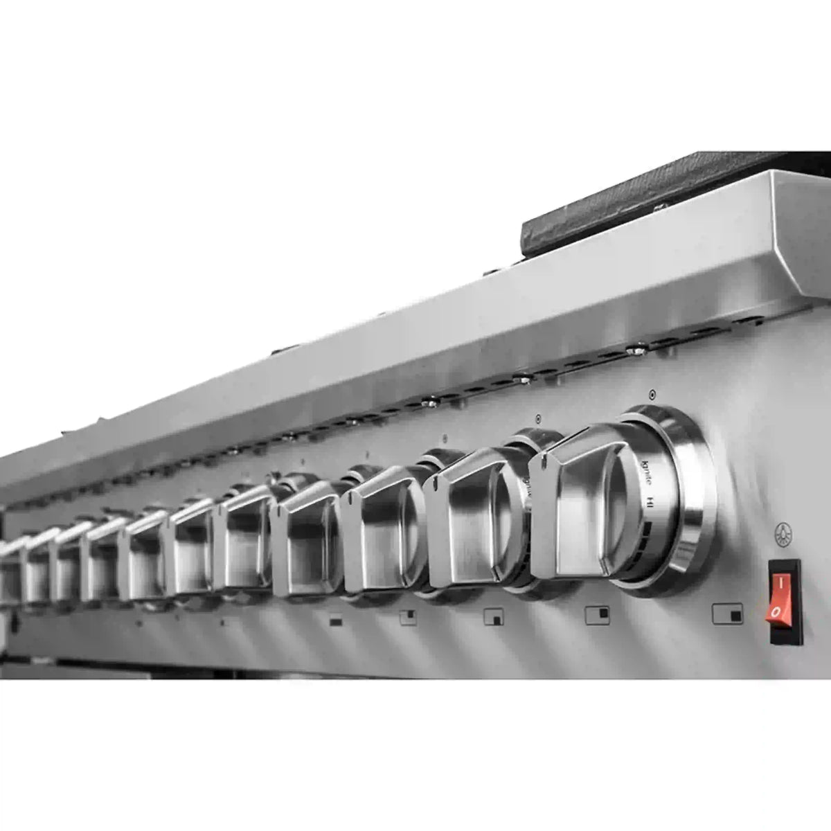 Stainless steel range control panel with row of metal knobs and switches