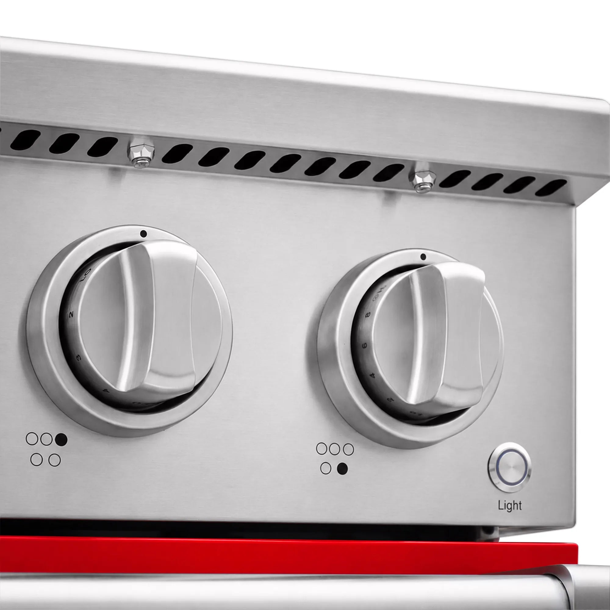 Electric range control knobs and vent slots on stainless panel with red lower trim