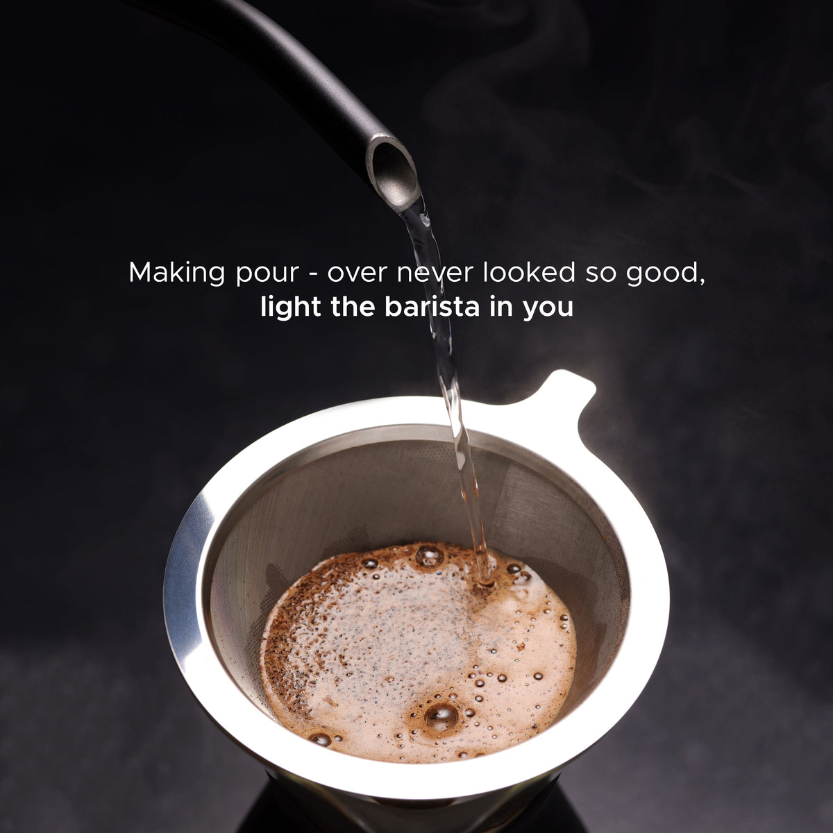 Matte black gooseneck kettle pouring coffee into stainless cup