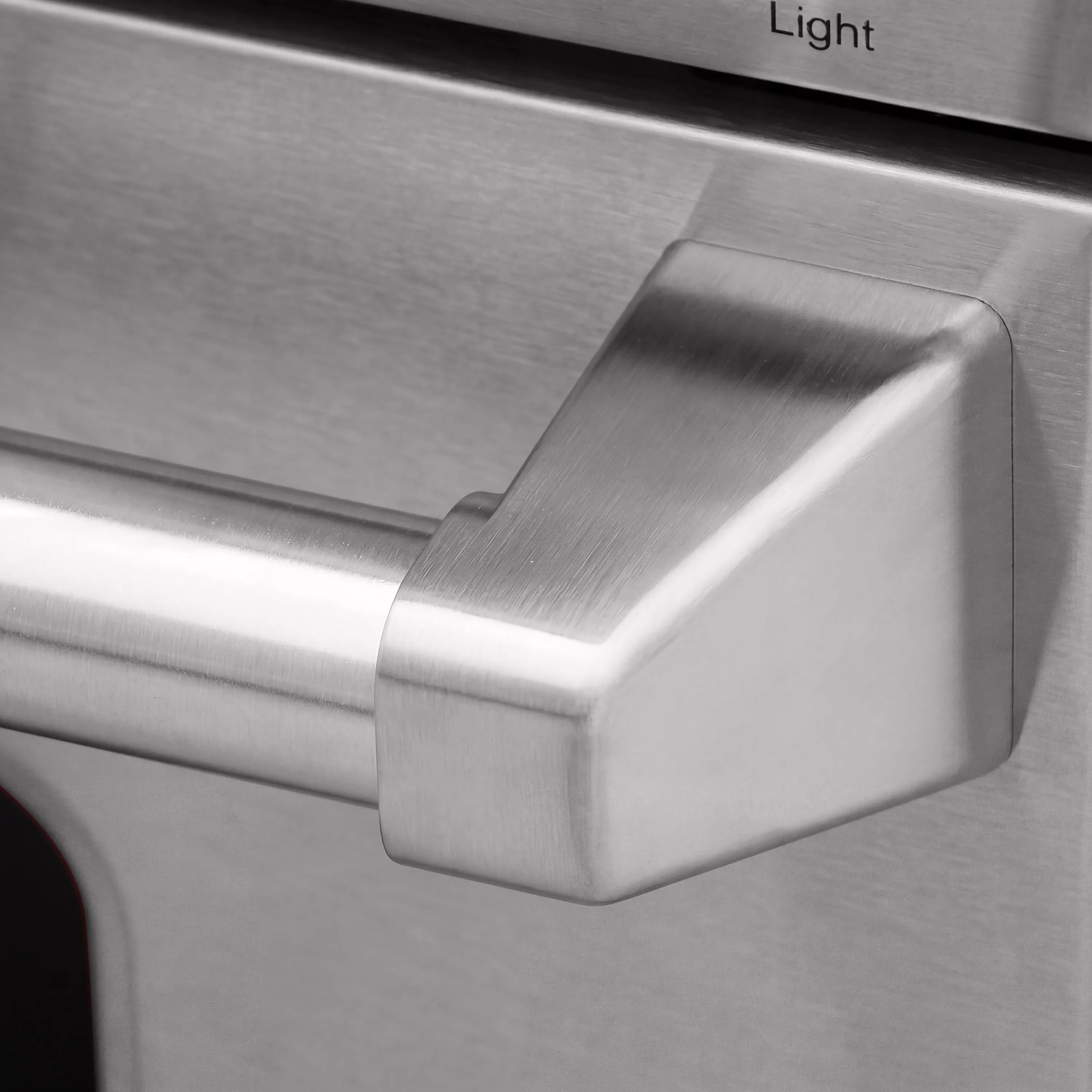 Tilt panel handle with “Light” label on stainless gas range control area