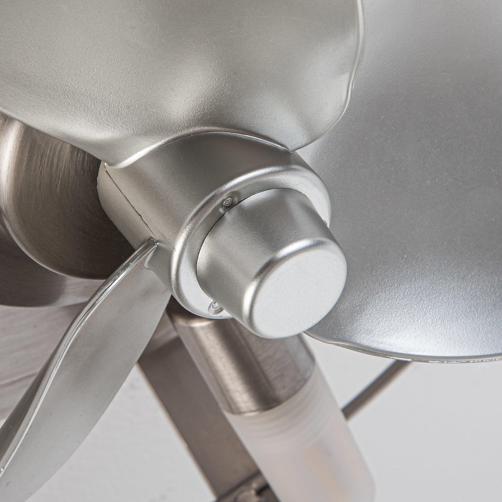 Close-up of satin nickel fan motor housing and light socket within the cage