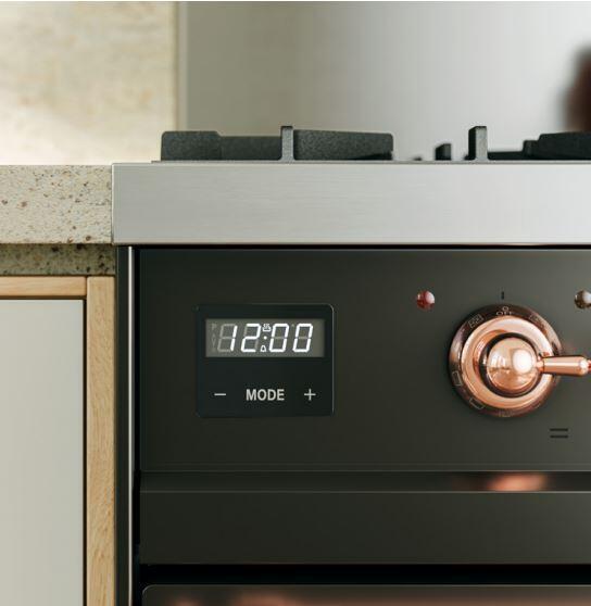 Dual fuel range control panel with digital display and copper-colored control knob