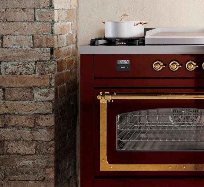 Burgundy freestanding range with open oven door and brass oven trim