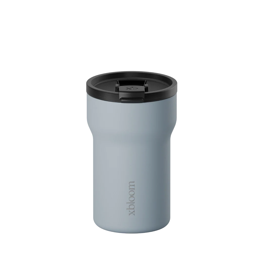 xBloom passenger tumbler in glacier blue with black lid and drinking opening