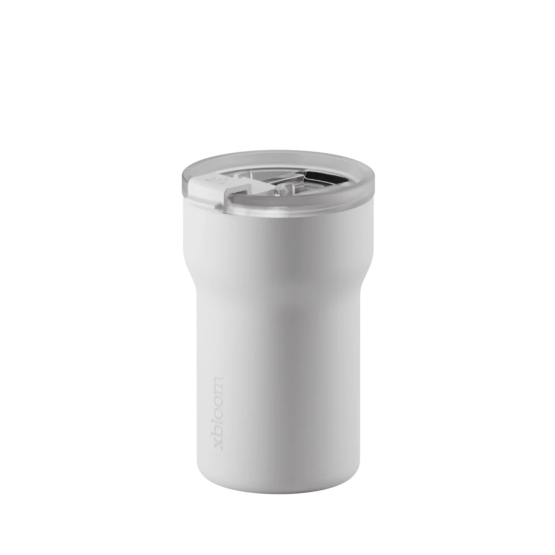 Cloud white passenger tumbler with translucent flip-top lid and drinking opening