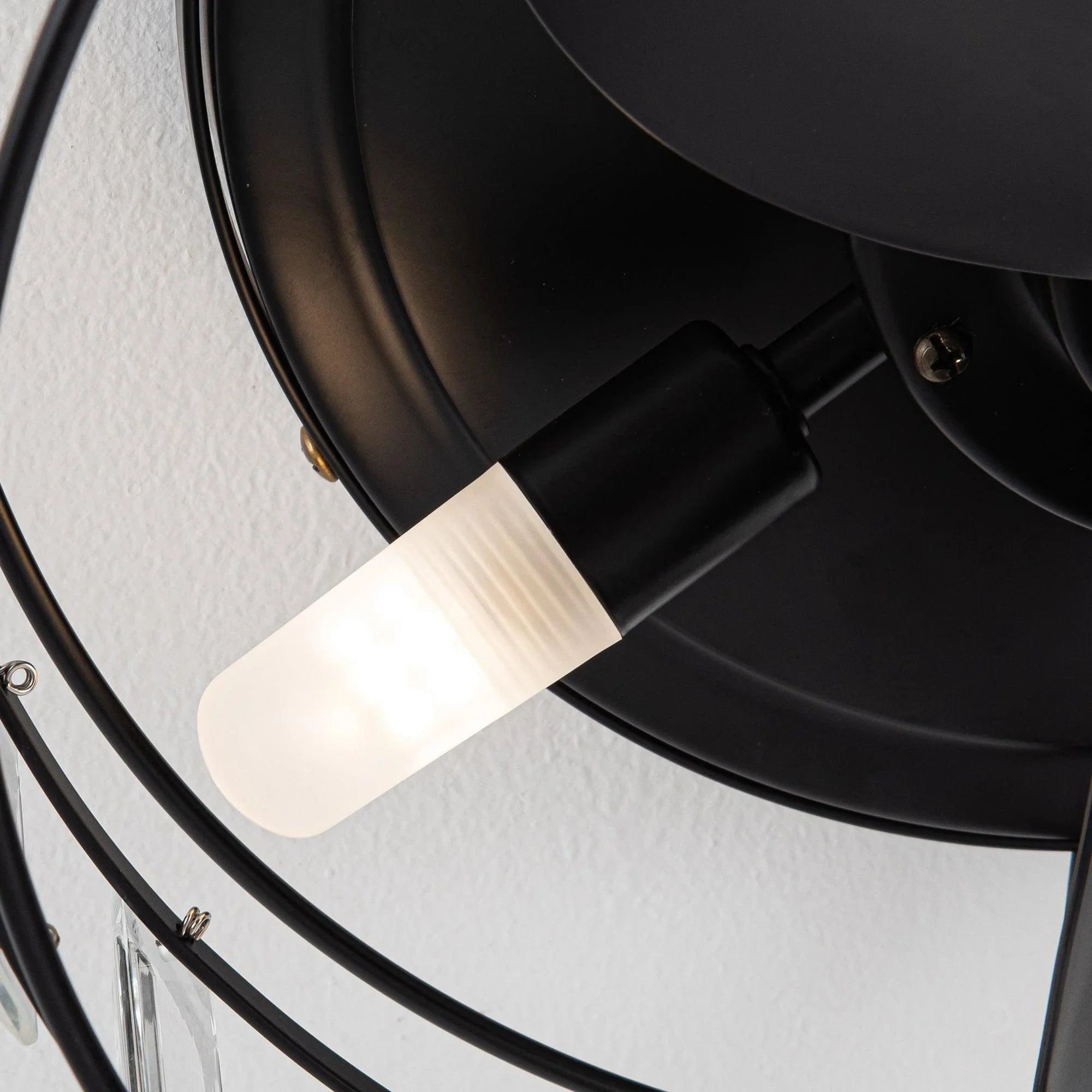 Black ceiling fan light housing with frosted white glass bulb cover