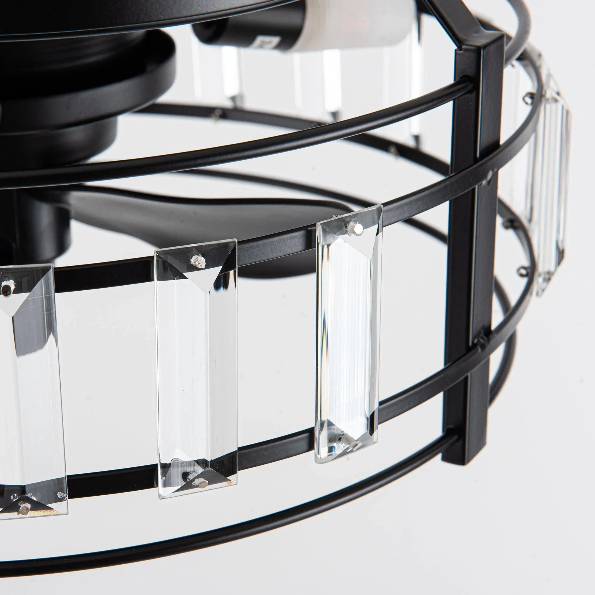 Crystal glass light shades along black metal ring on flush mount fan
