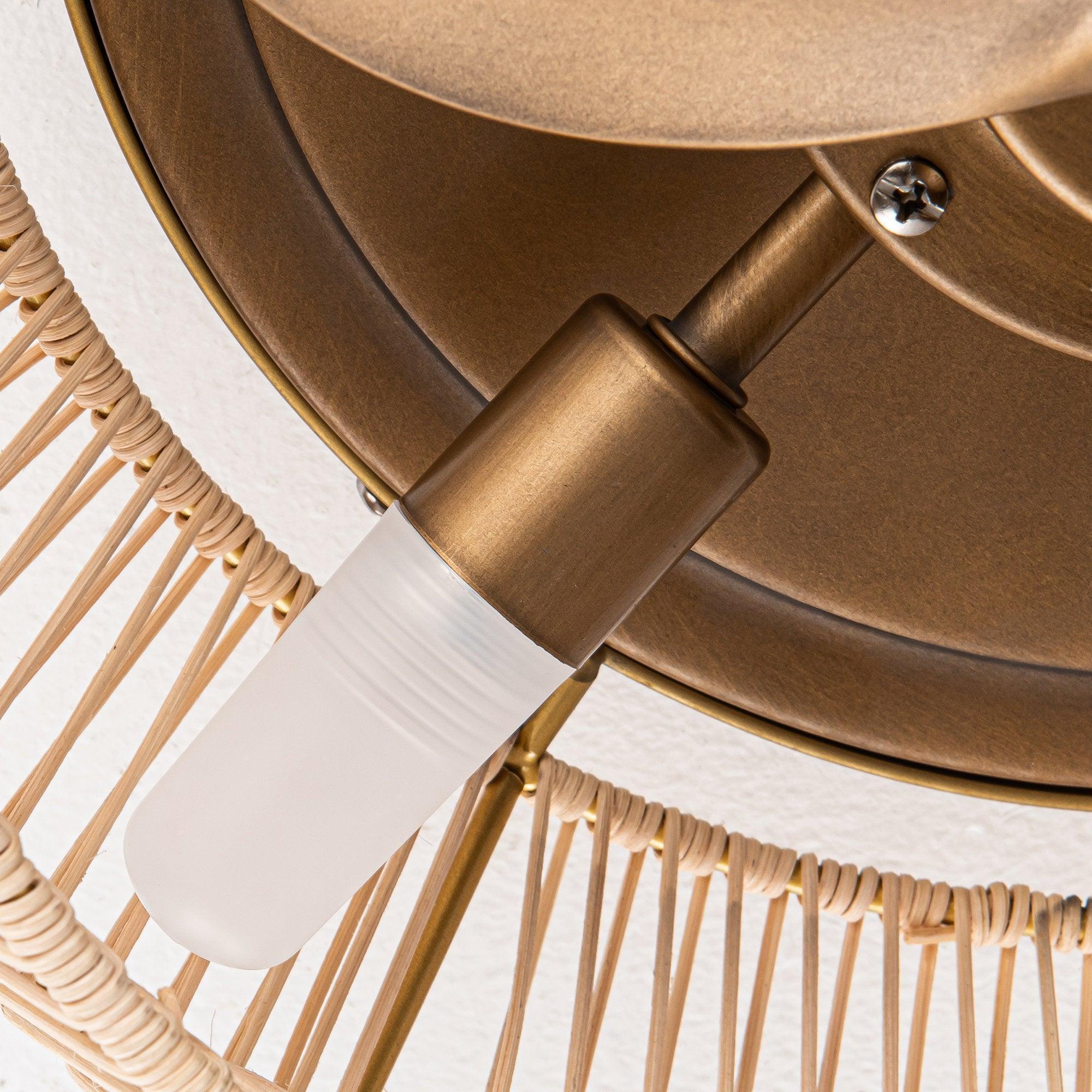Close-up of golden ceiling fan blade and bronze-toned motor housing connector