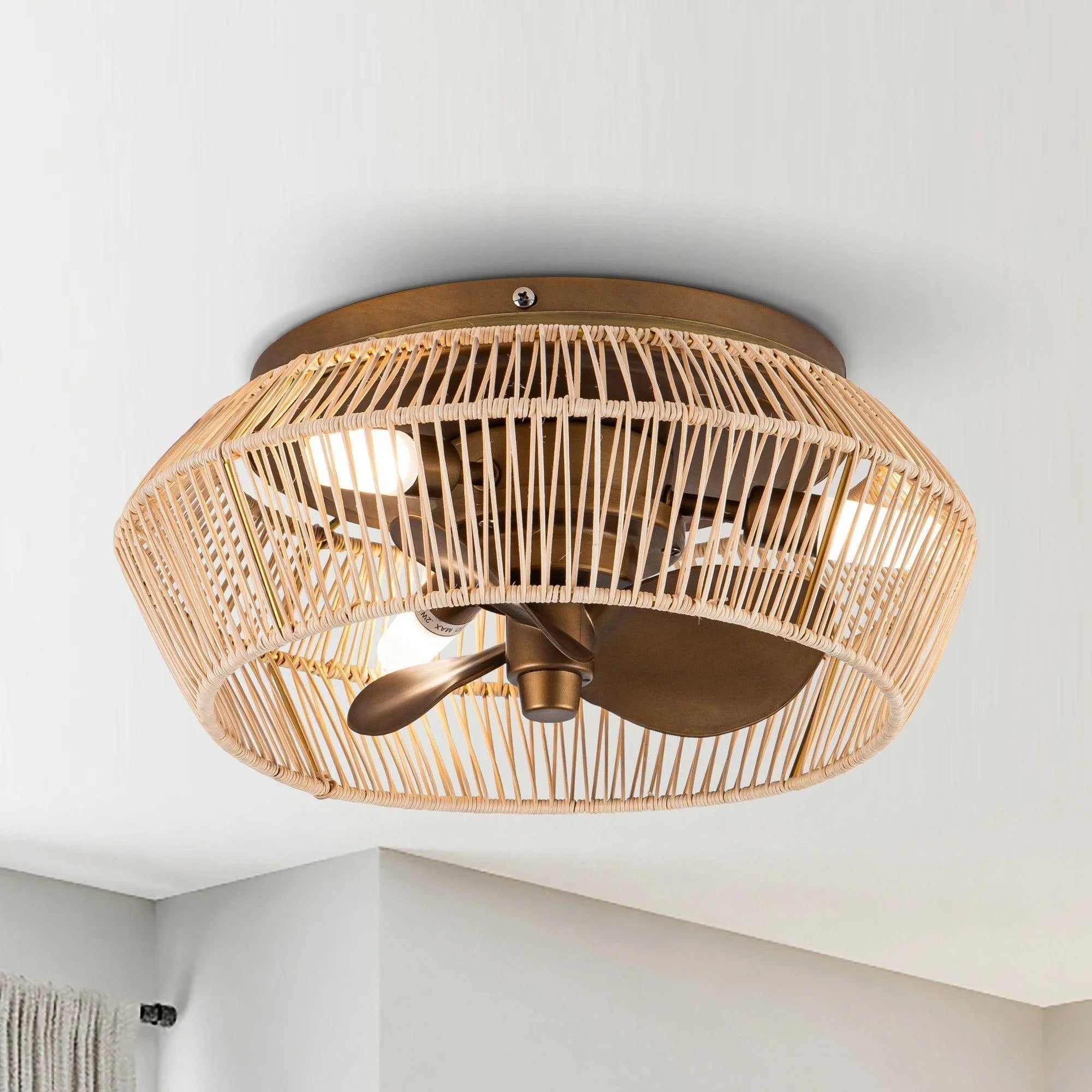 Golden flush-mount ceiling fan with rattan-style globe housing and LED light kit