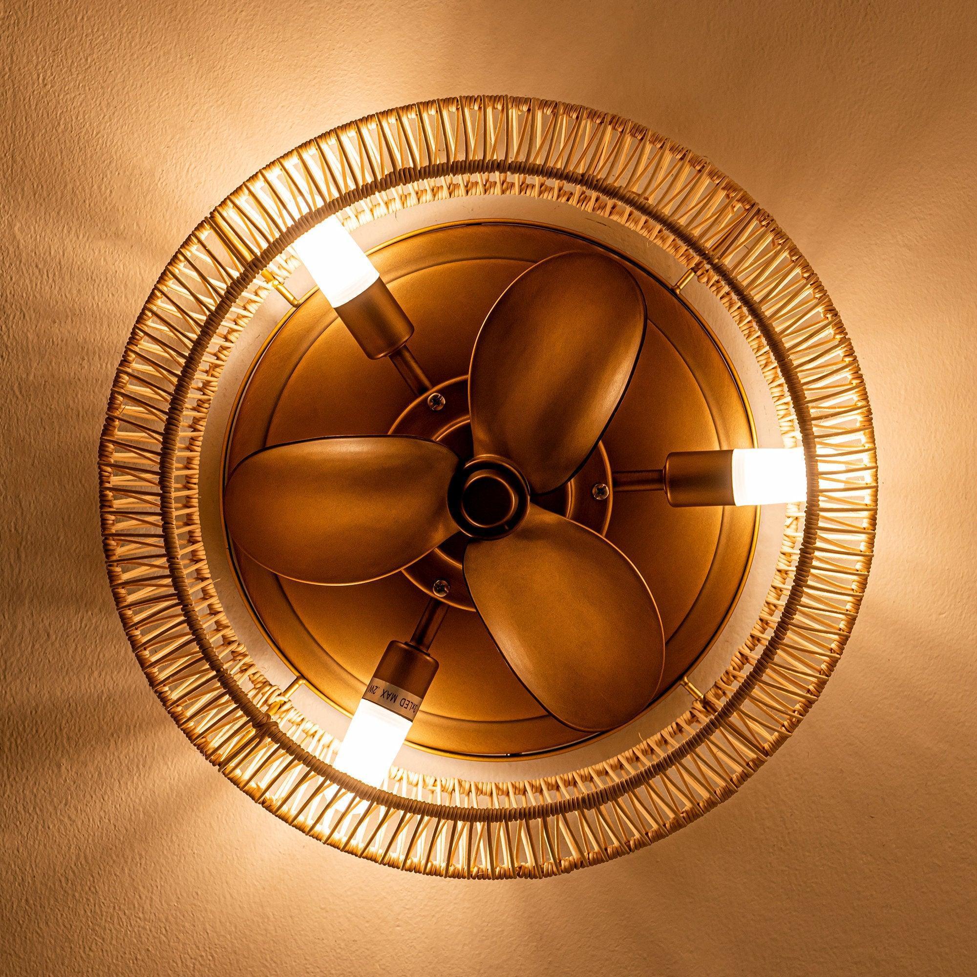 Golden flush-mount ceiling fan underside view with three dark blades and light sockets