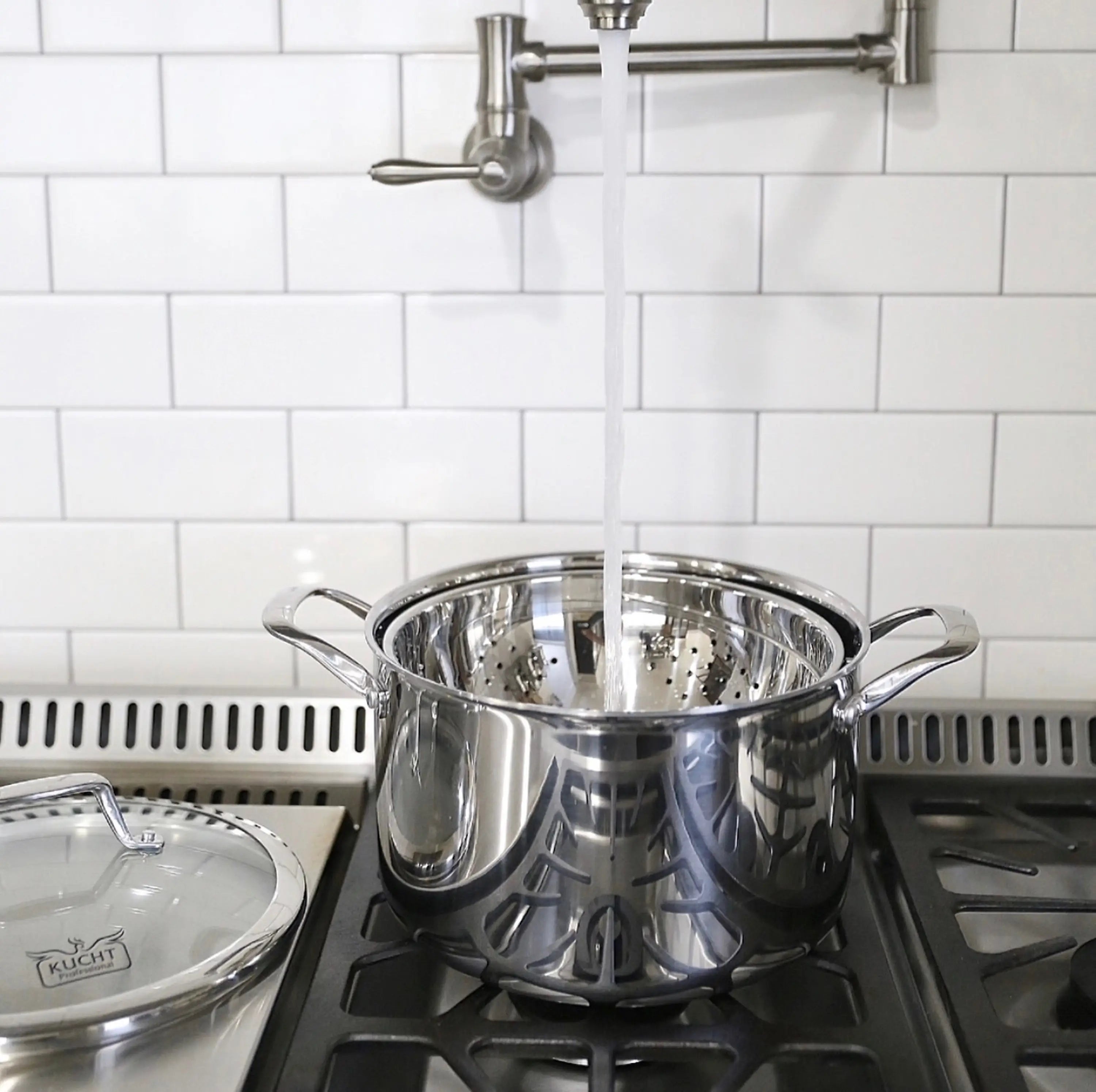 Stainless steel stockpot with lid on black stovetop