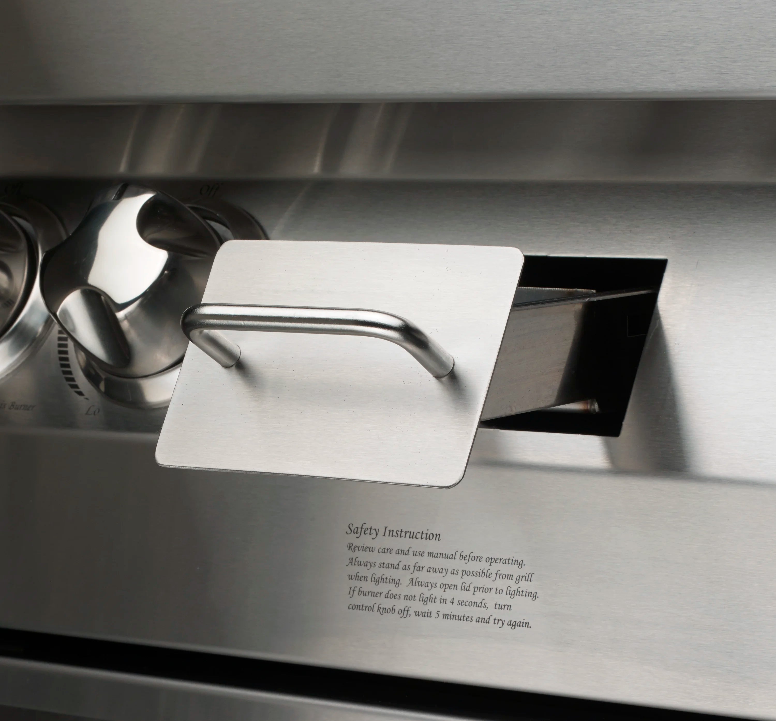 Stainless grill access panel with handle and safety warning label