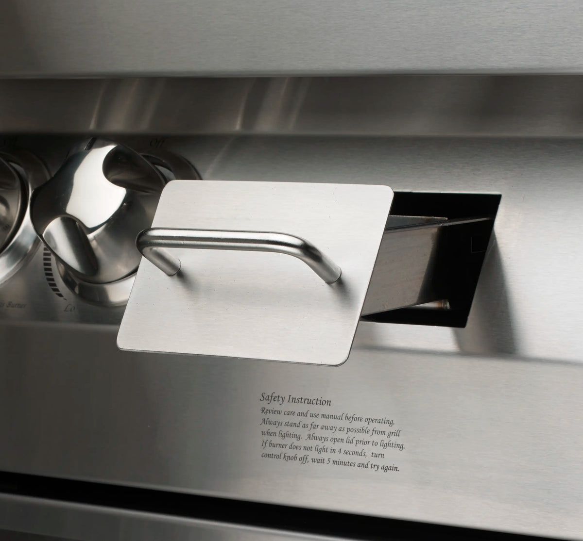 Stainless steel grill lid with handle and safety instruction label
