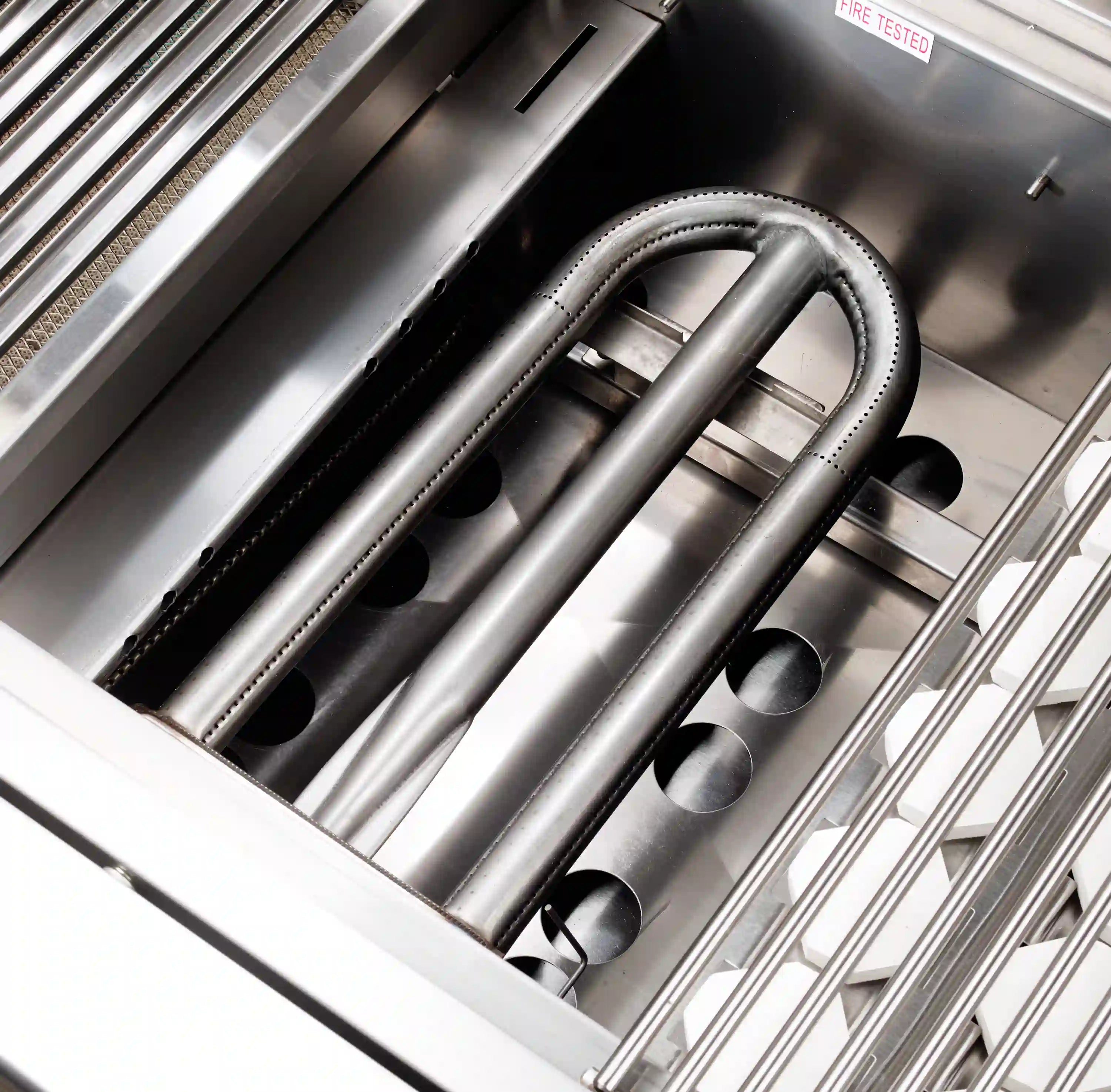 Stainless steel grill burner tubes and heat shield inside the firebox