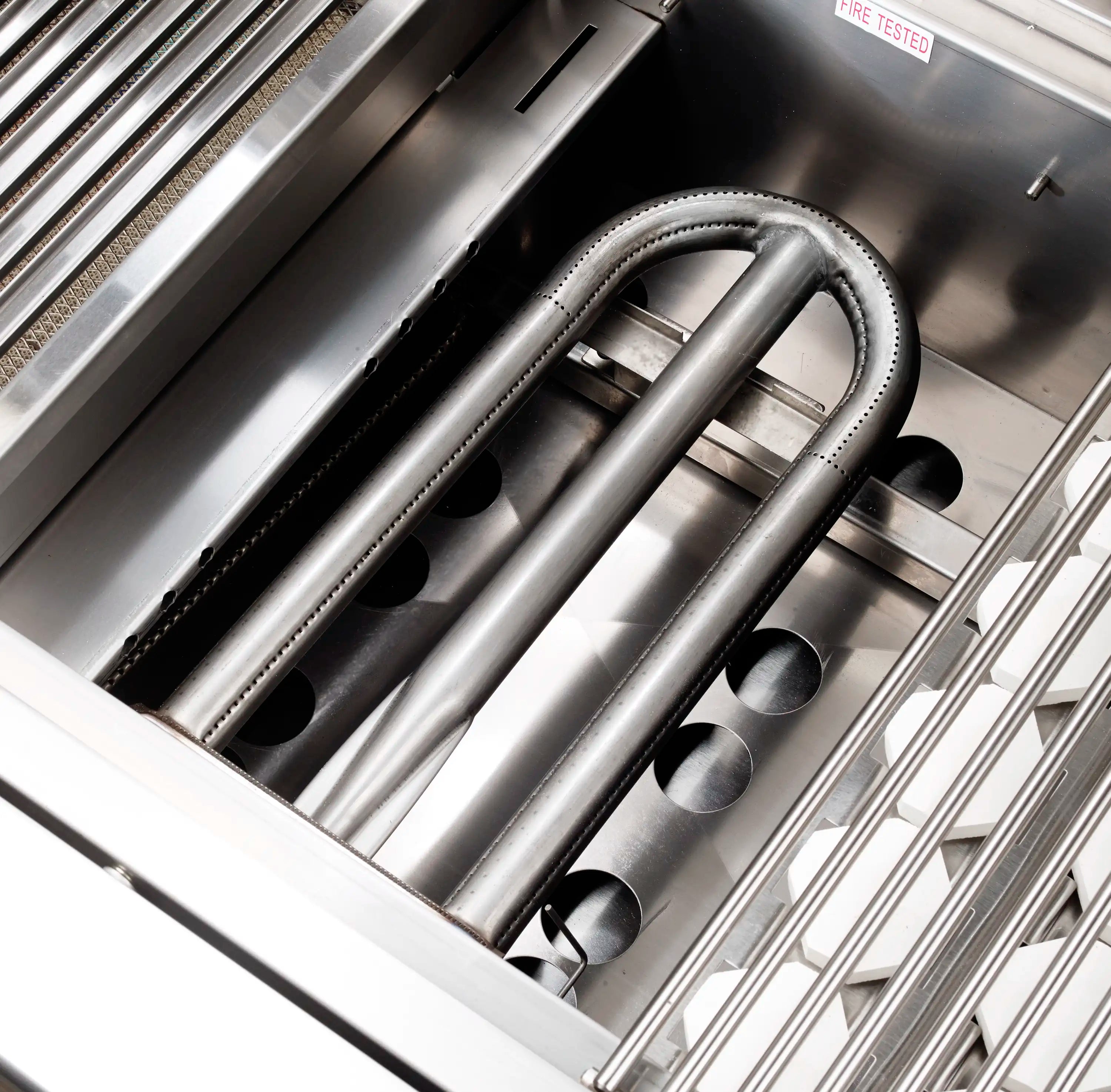 Stainless grill burner tubes with ignition area inside the firebox