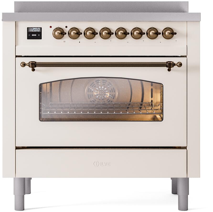 Freestanding electric induction range with bronze knobs and lit oven window in antique white