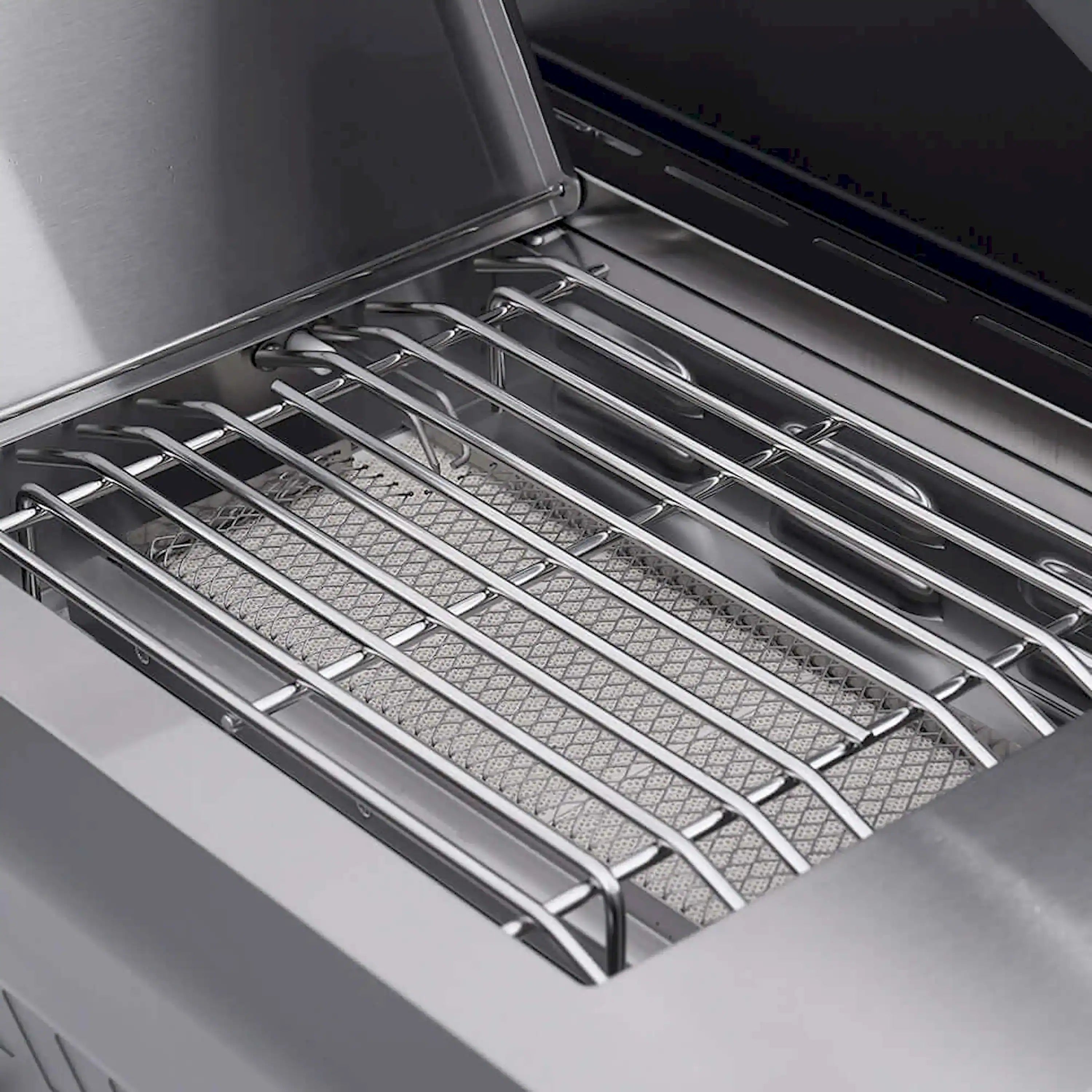 Open grill firebox with stainless steel cooking grates and heat shield panels