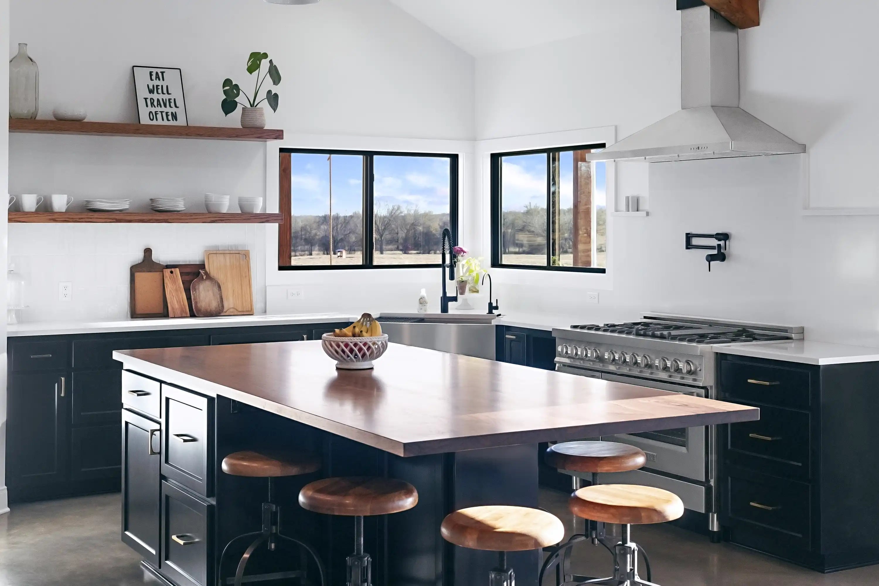 Stainless steel range hood mounted on a wall above the cooktop
