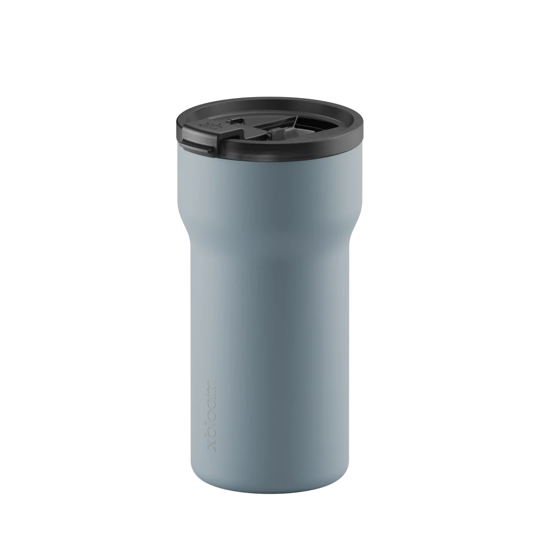 Light blue passenger tumbler with lid opened for sipping