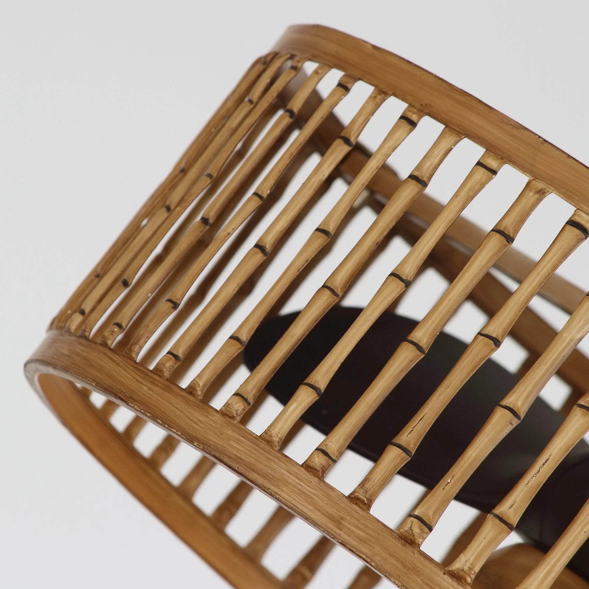 Close-up of brown slatted drum ceiling fan with curved wooden frame