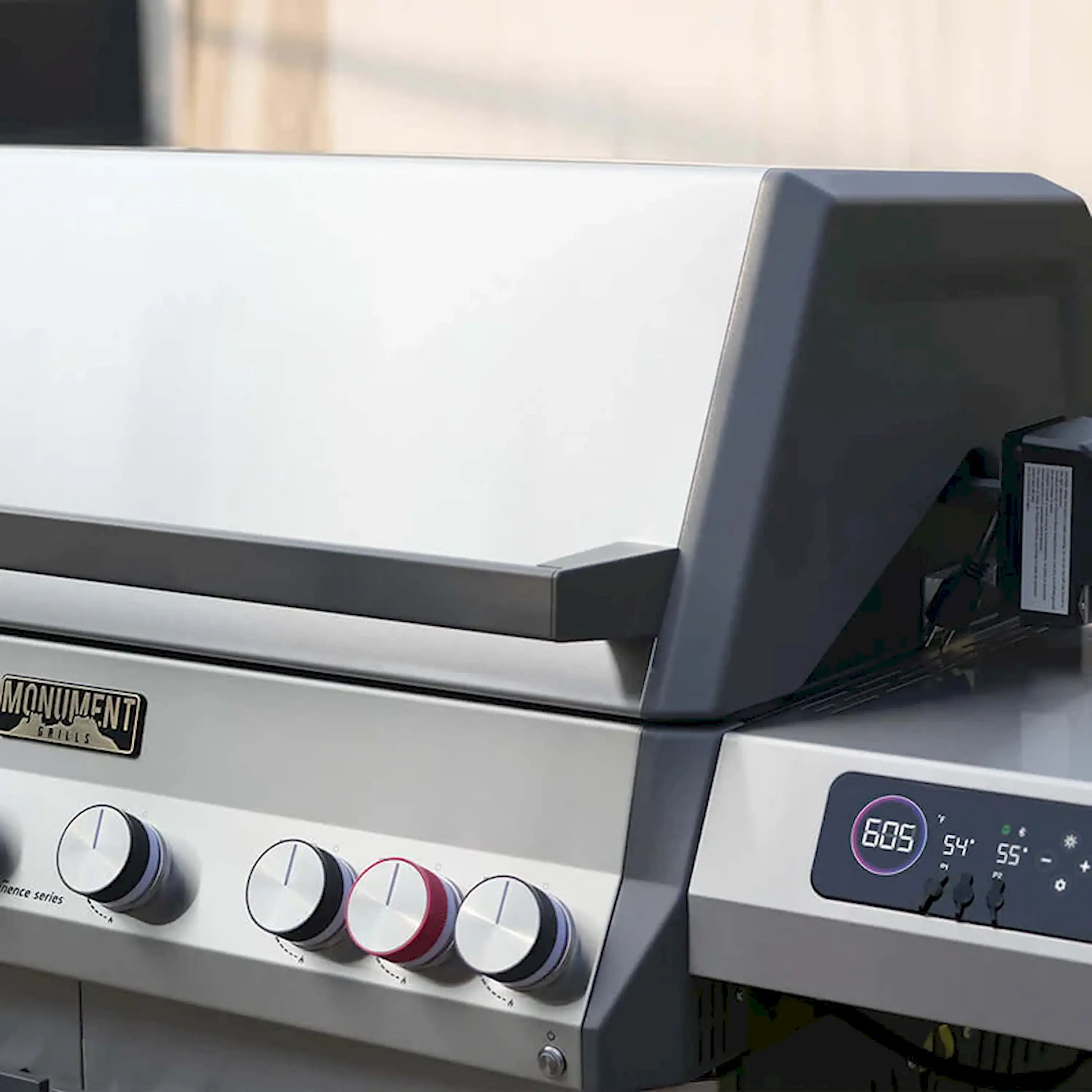 Stainless steel gas grill control panel with front knobs and display