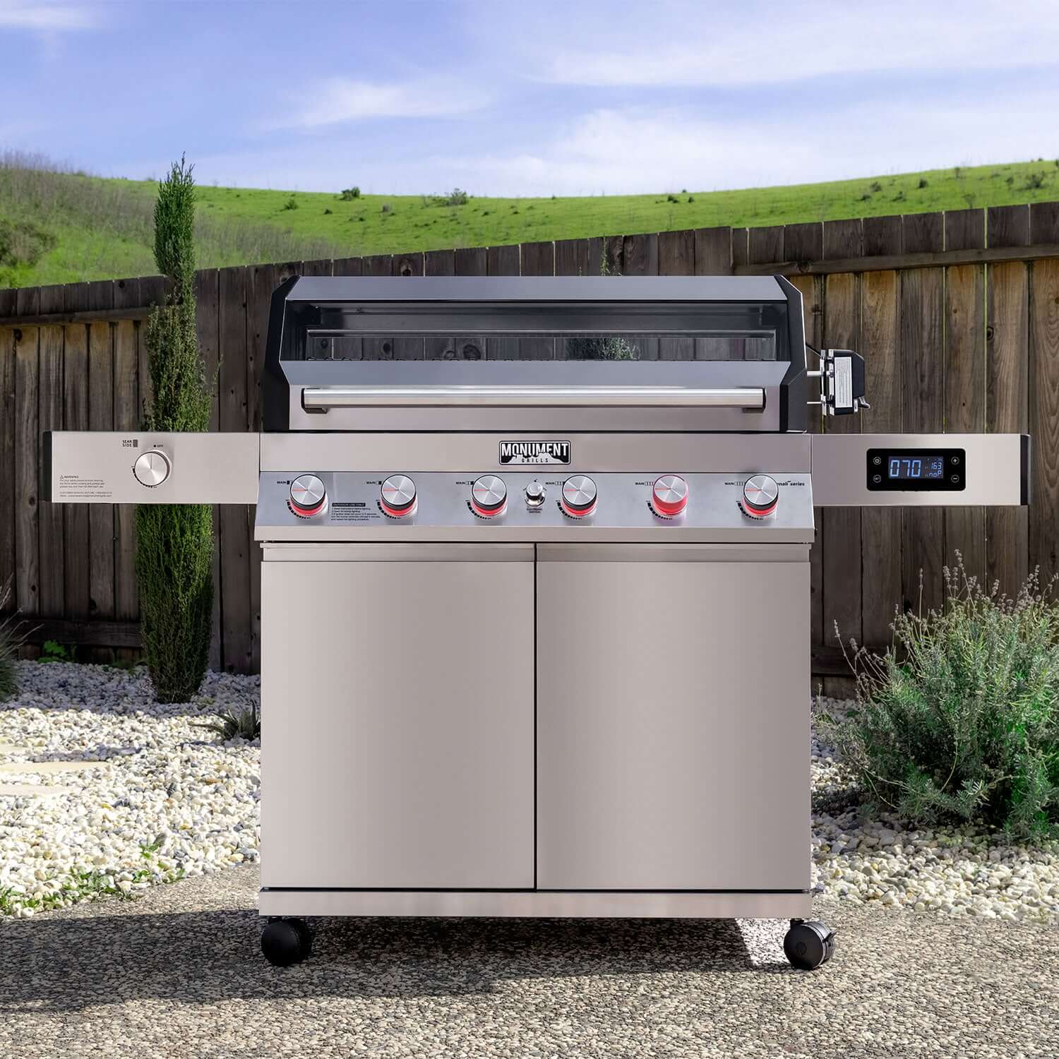 Stainless propane gas grill with six burner knobs and digital display on the control front