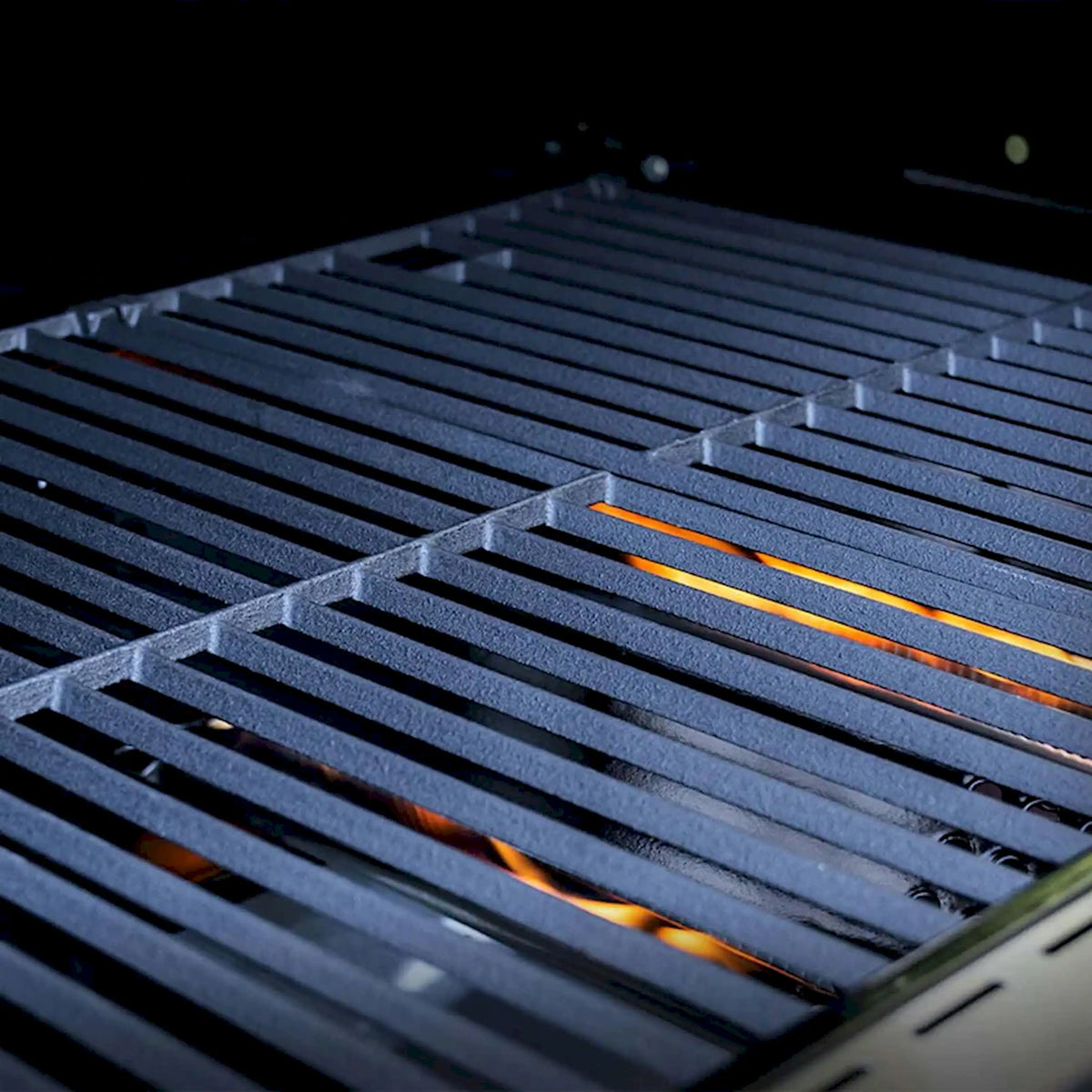 Stainless grill grates with glowing orange heating lines from infrared burners