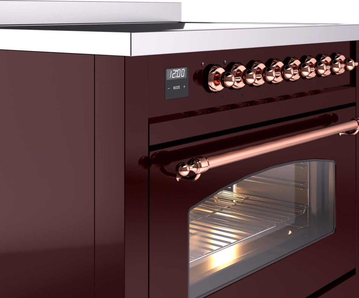 Burgundy freestanding range showing copper control knobs and oven door window