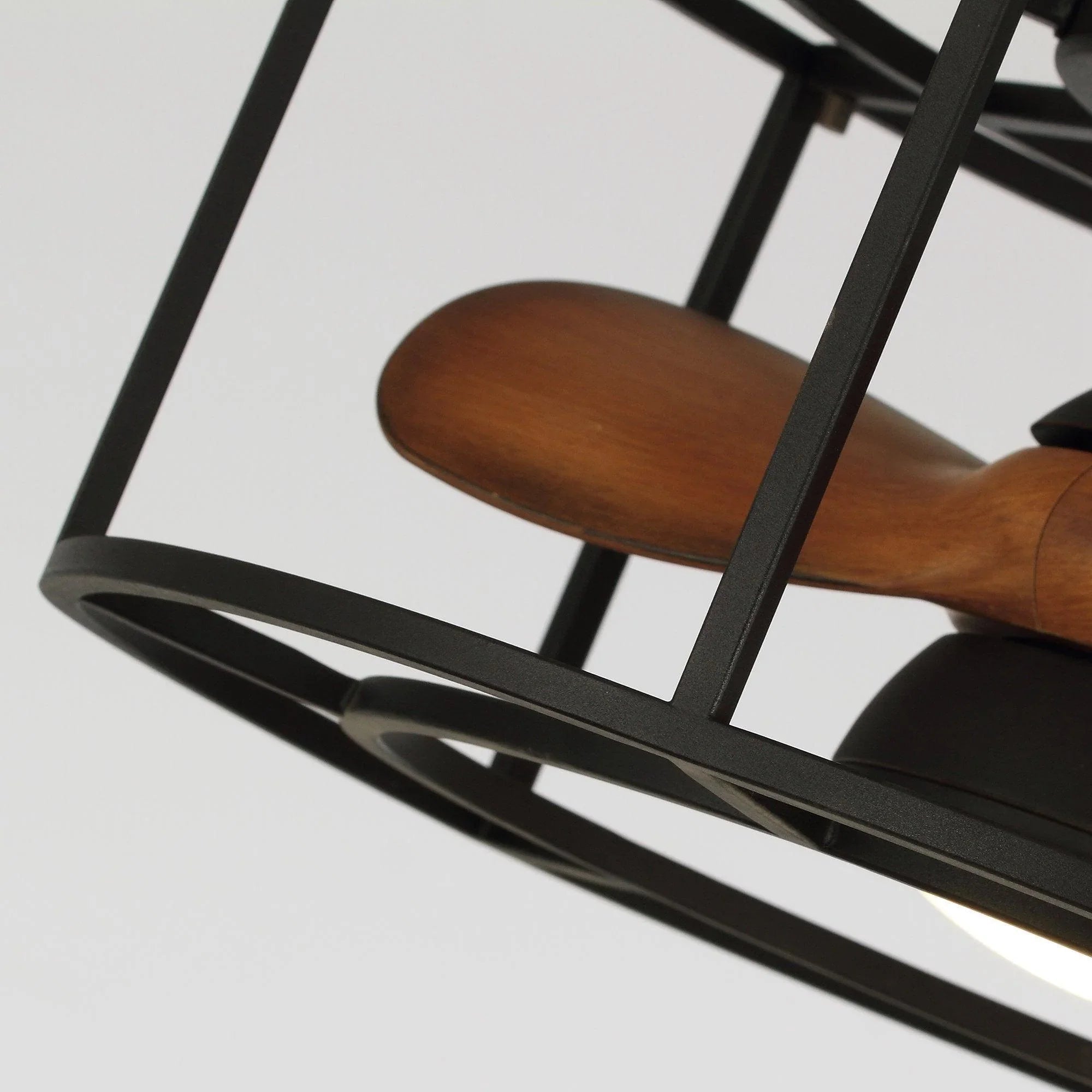 Black metal fan cage with a brown blade visible near the edge
