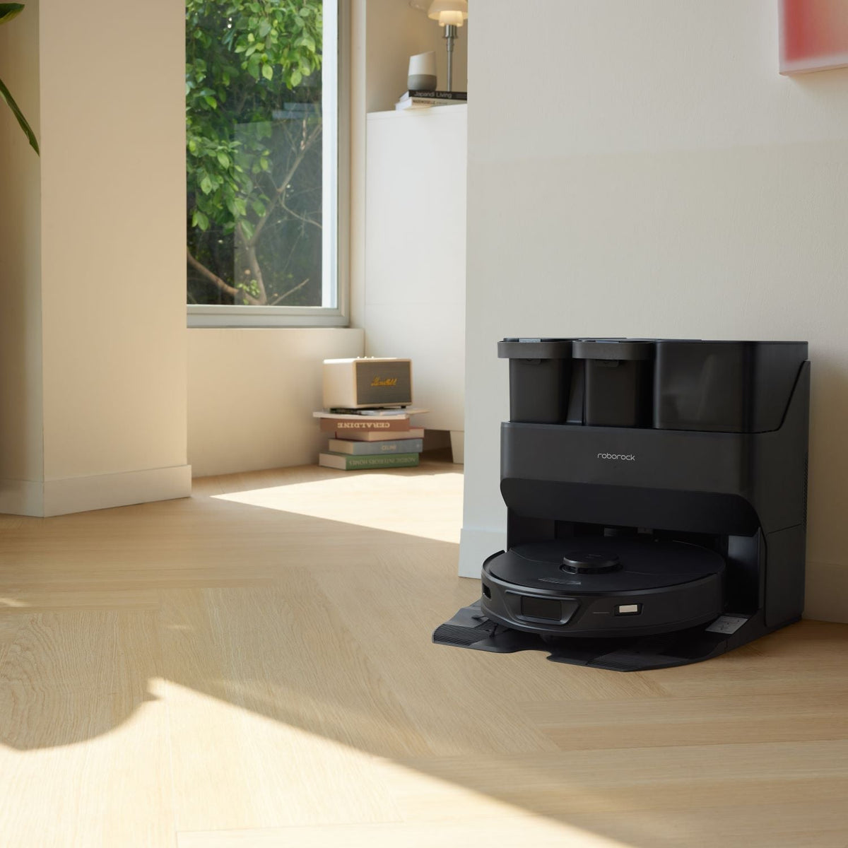 Black robot vacuum dock with robot resting inside