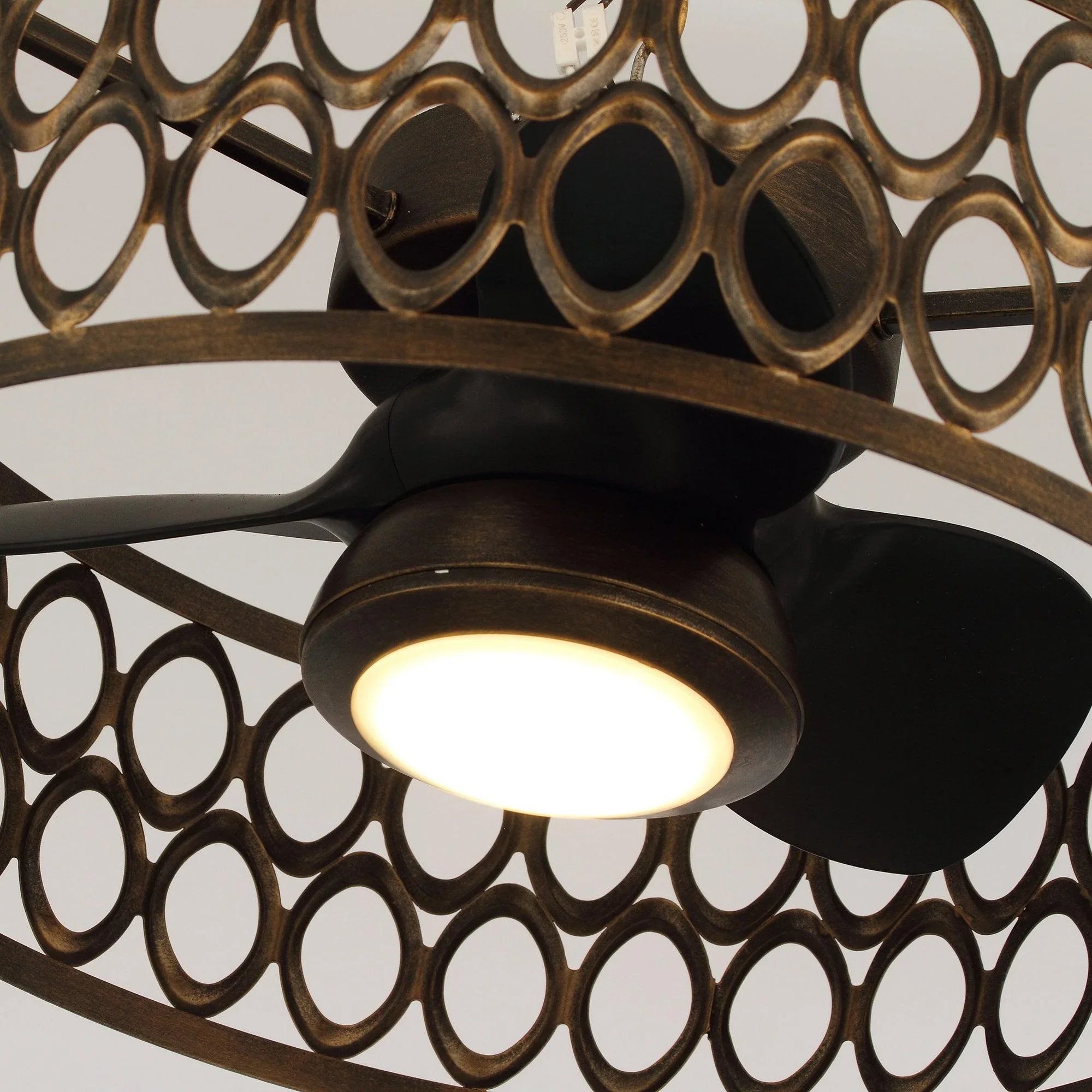 Black flush mount ceiling fan with warm LED glow and decorative circular grill