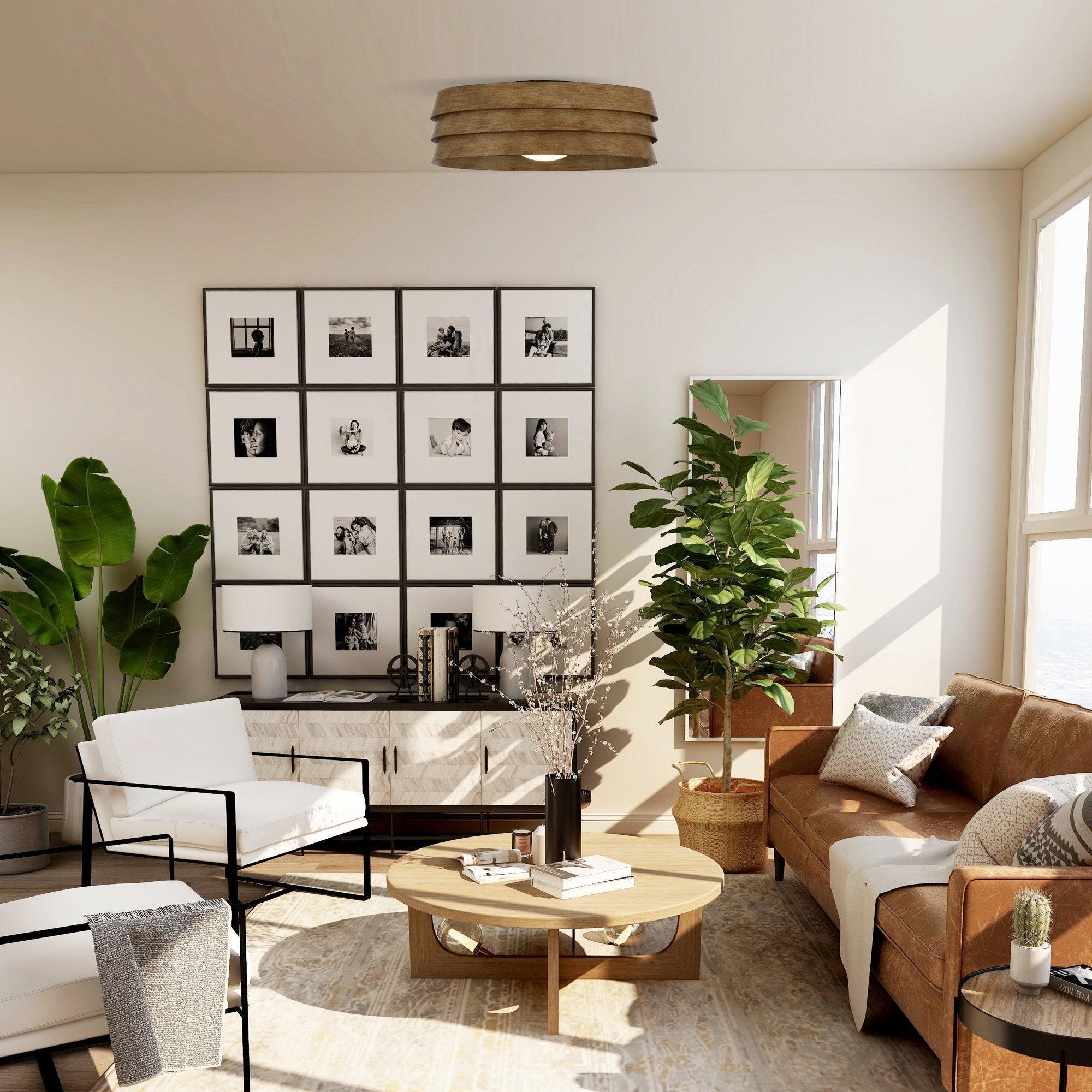 Brown flush mount LED ceiling fan centered in room ceiling, with drum-shaped wood-look shade