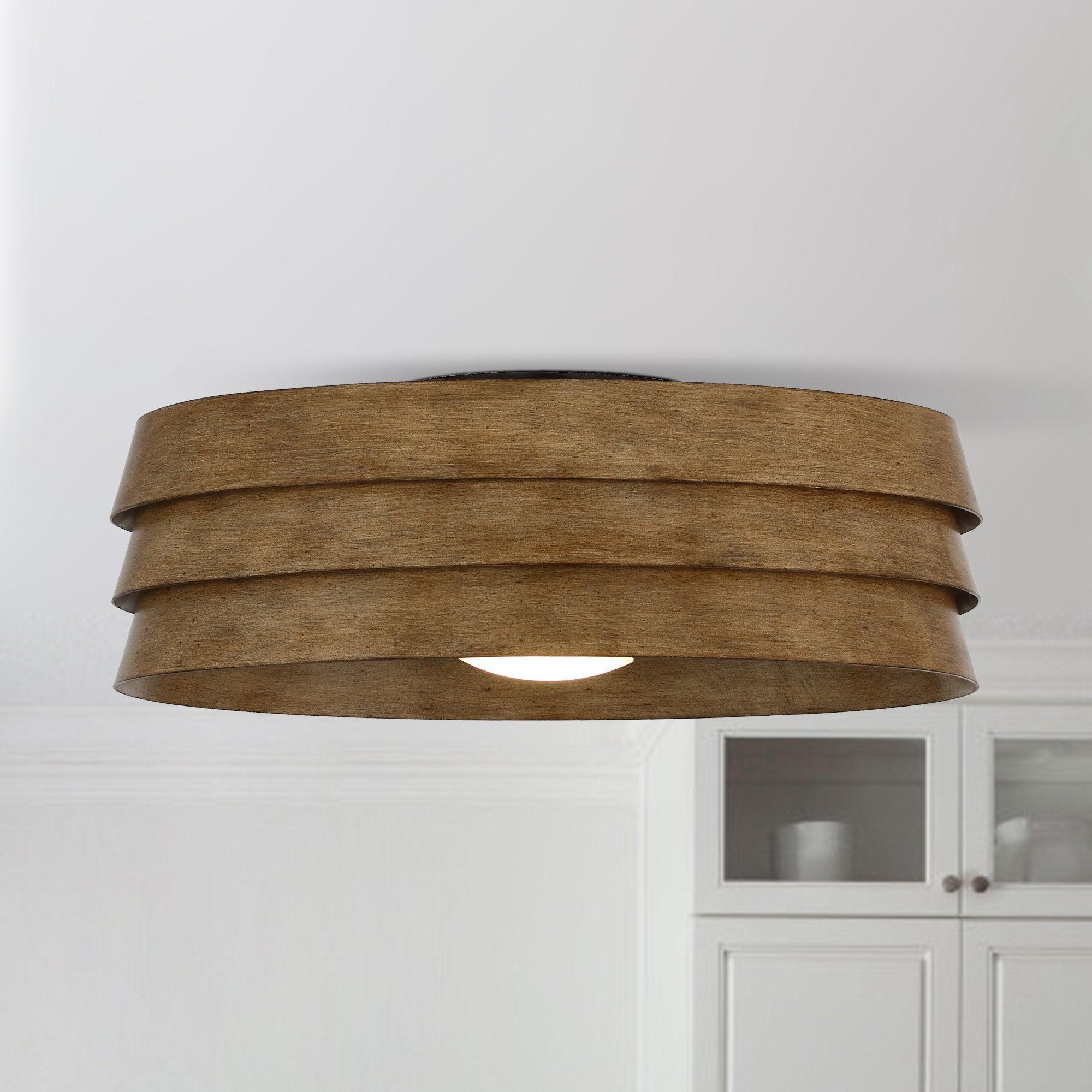 Brown flush mount ceiling fan with integrated LED light and layered drum wood-look shade