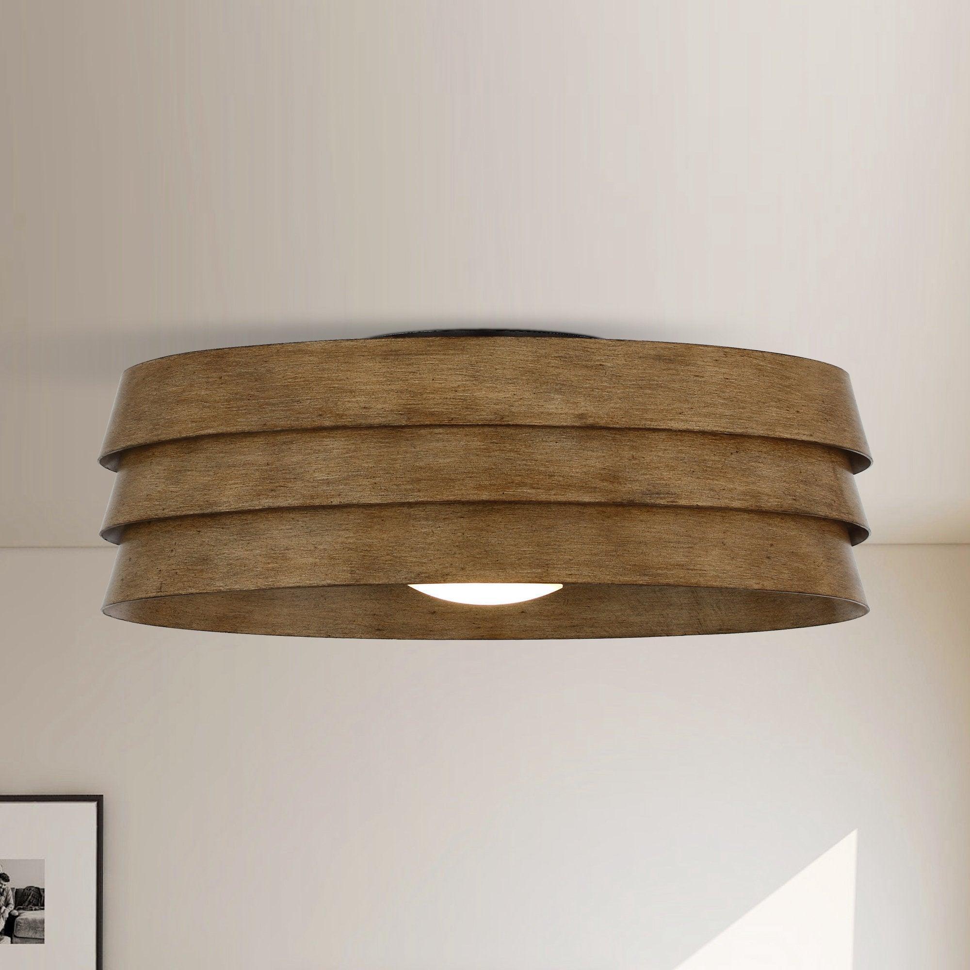 Brown flush mount ceiling fan with integrated LED and layered wood-look drum shade