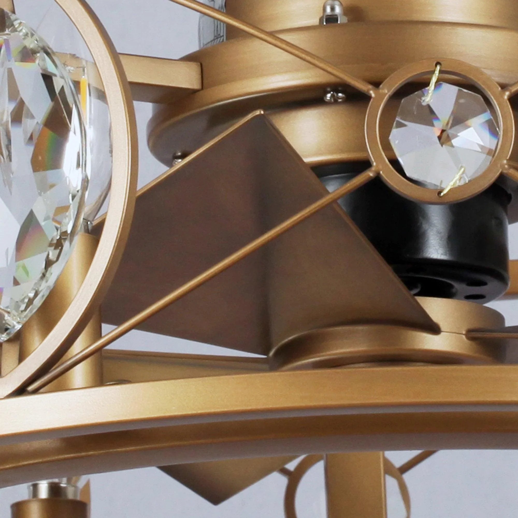 Golden ceiling fan light with geometric metal cage and crystal prism details