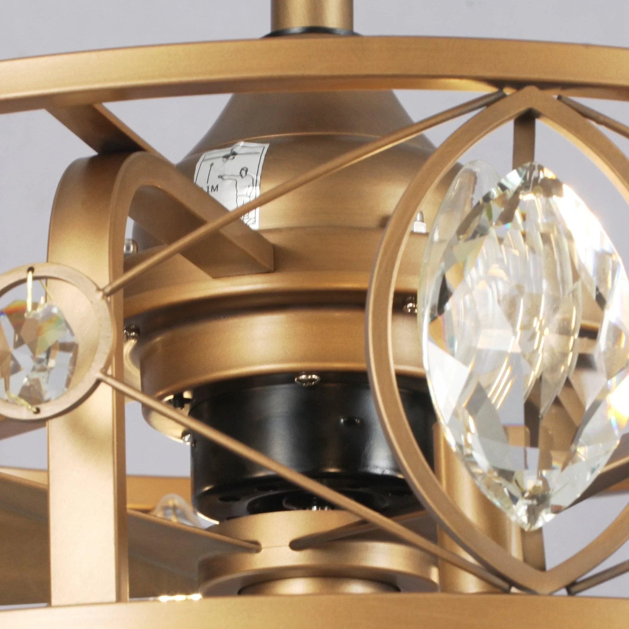 Gold ceiling fan chandelier close-up of crystal ring and inner motor housing