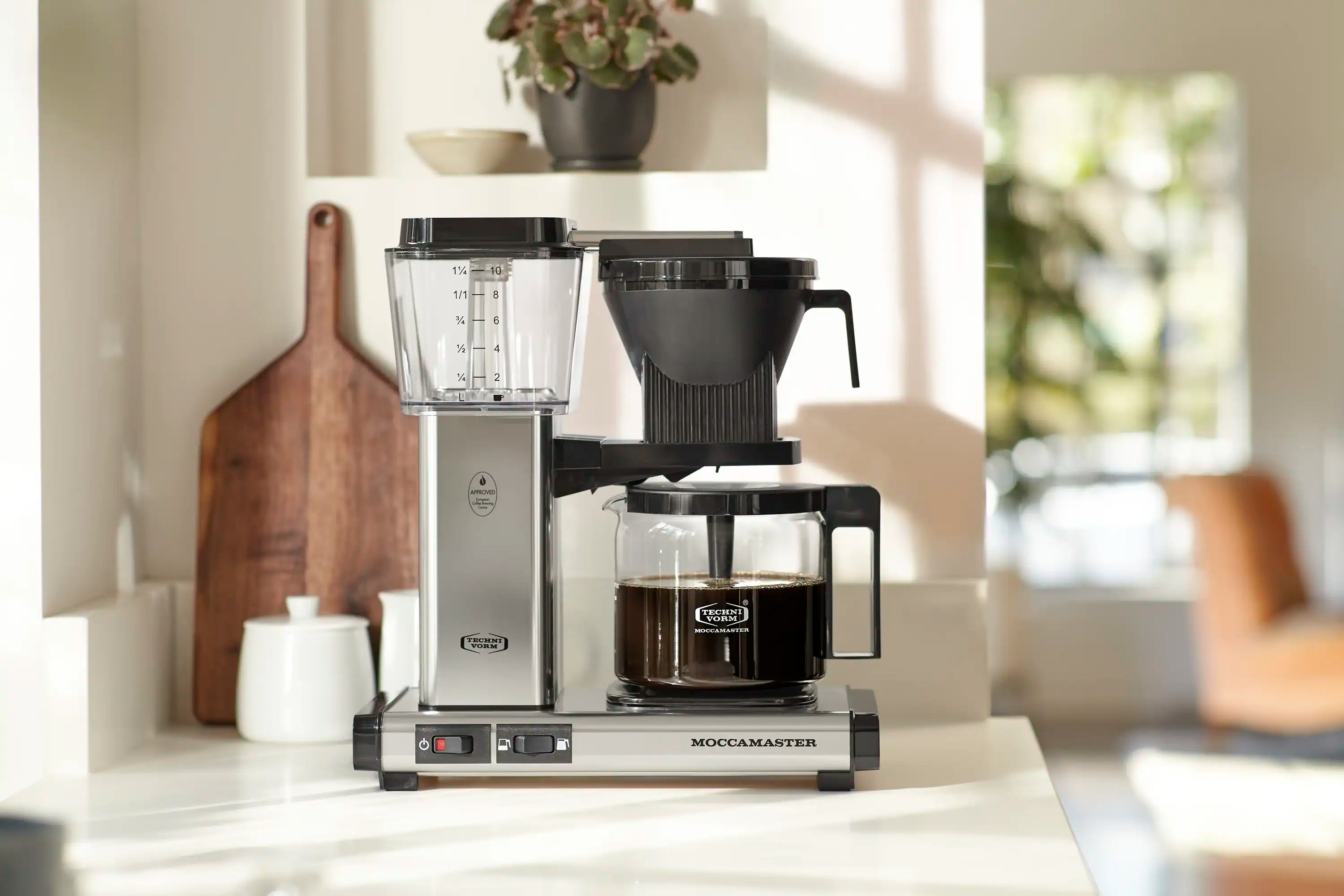 10-cup Moccamaster coffee maker with glass carafe, polished silver body and drip-stop.