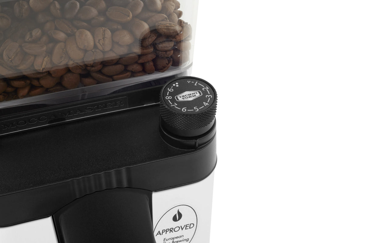 Matte white burr grinder side view with coffee bean hopper and black grind selector dial.