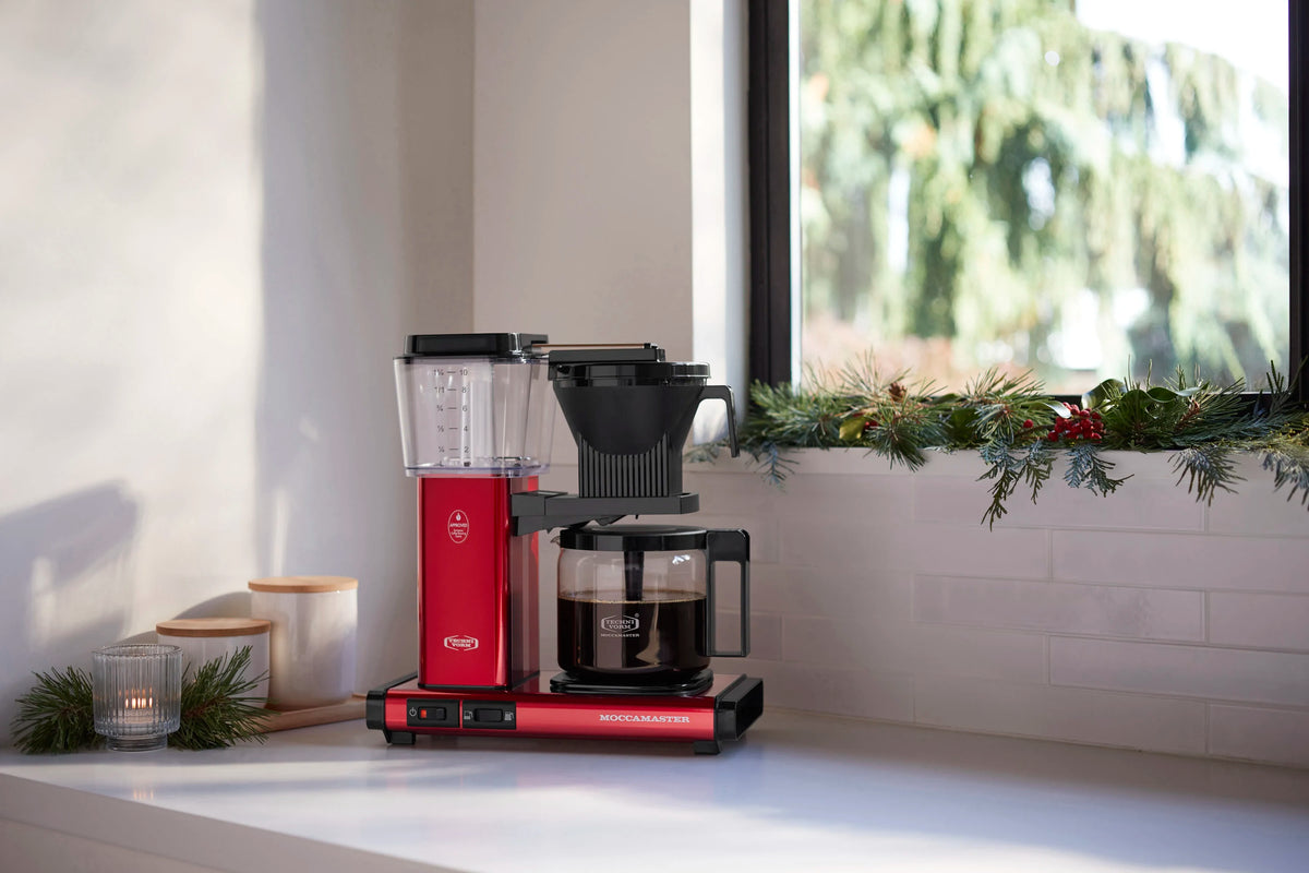 Candy apple red coffee maker with glass carafe and black filter holder