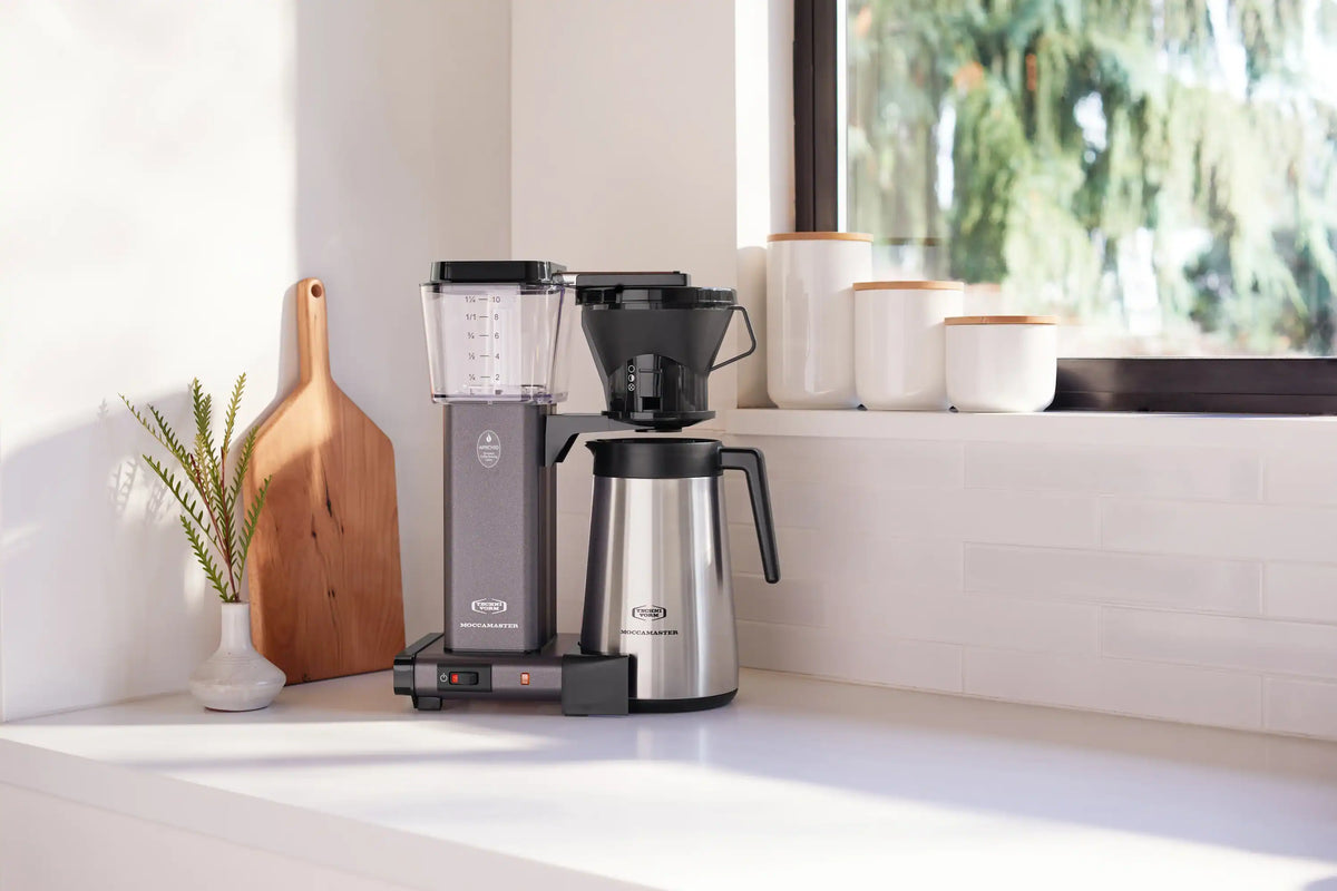 Compact thermal coffee maker with stone grey body and stainless carafe