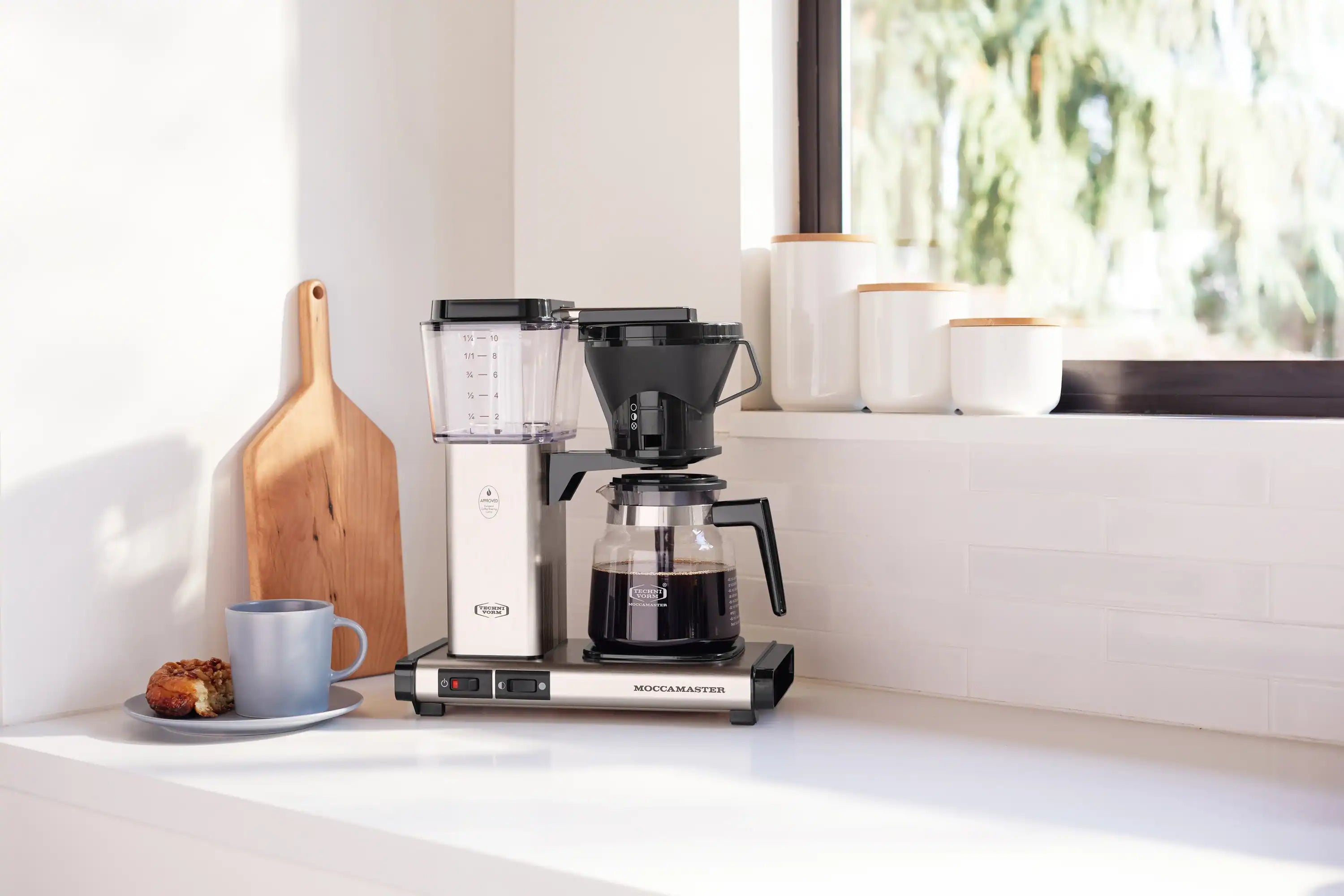 Brushed silver 10-cup thermal carafe coffee maker with black filter, shown on countertop
