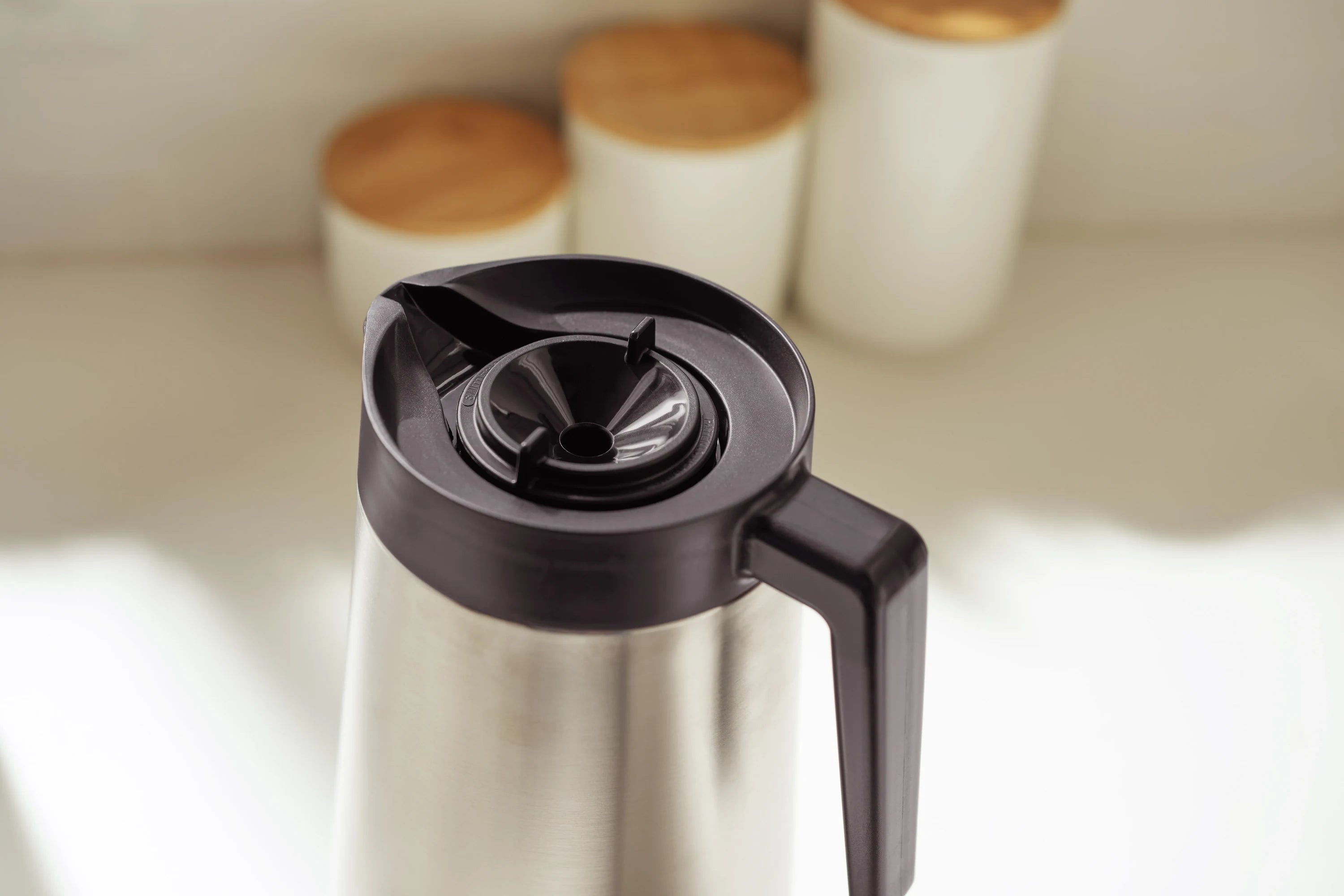 Stainless thermal coffee carafe lid and pour opening with black top section