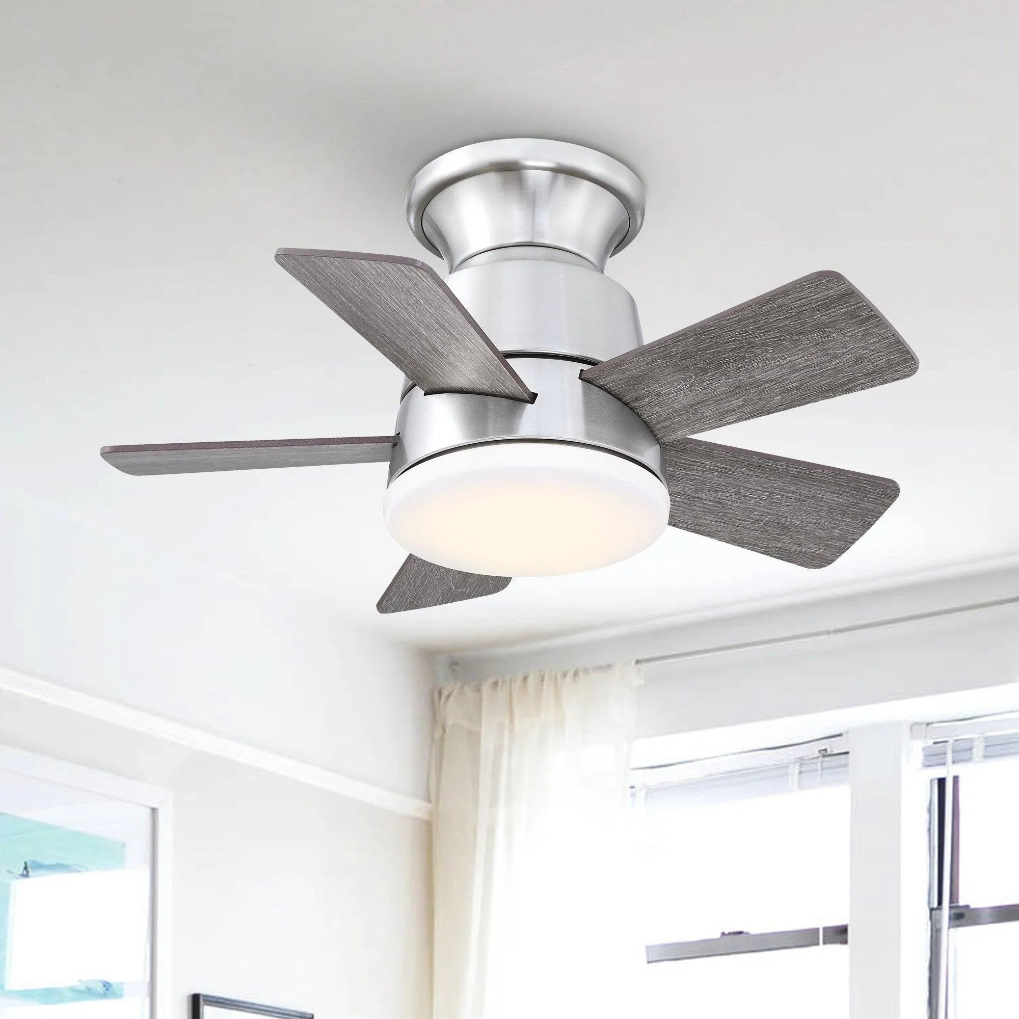 Brushed nickel ceiling fan with wood blades and frosted light dome on flush mount