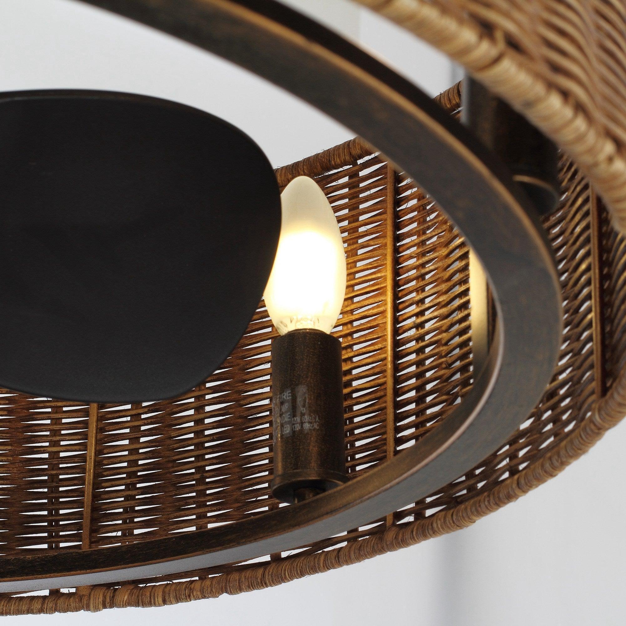 Woven wicker ceiling fan with oil-rubbed bronze light housing and glowing bulb