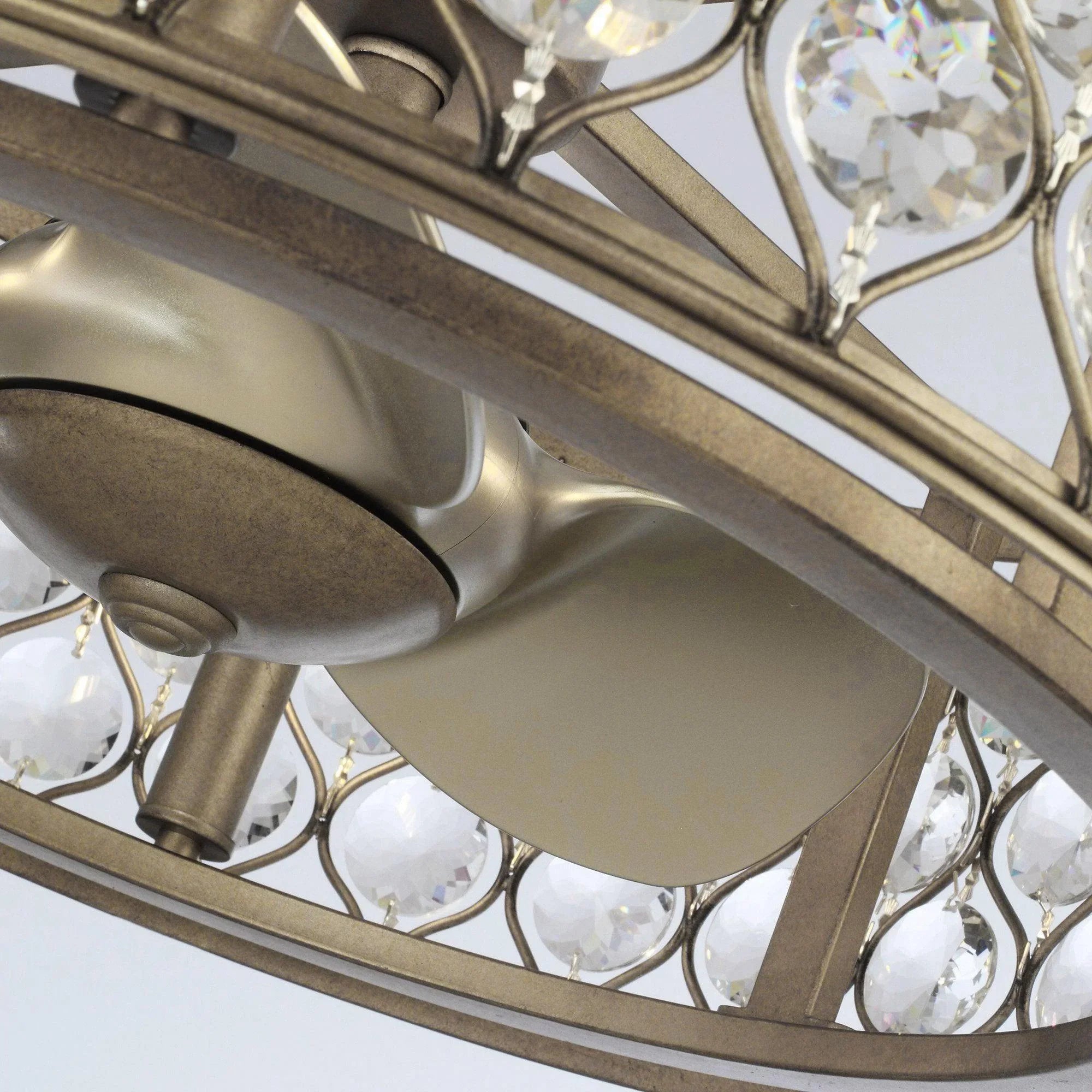 Gold ceiling fan chandelier underside with crystal accents and three curved blades