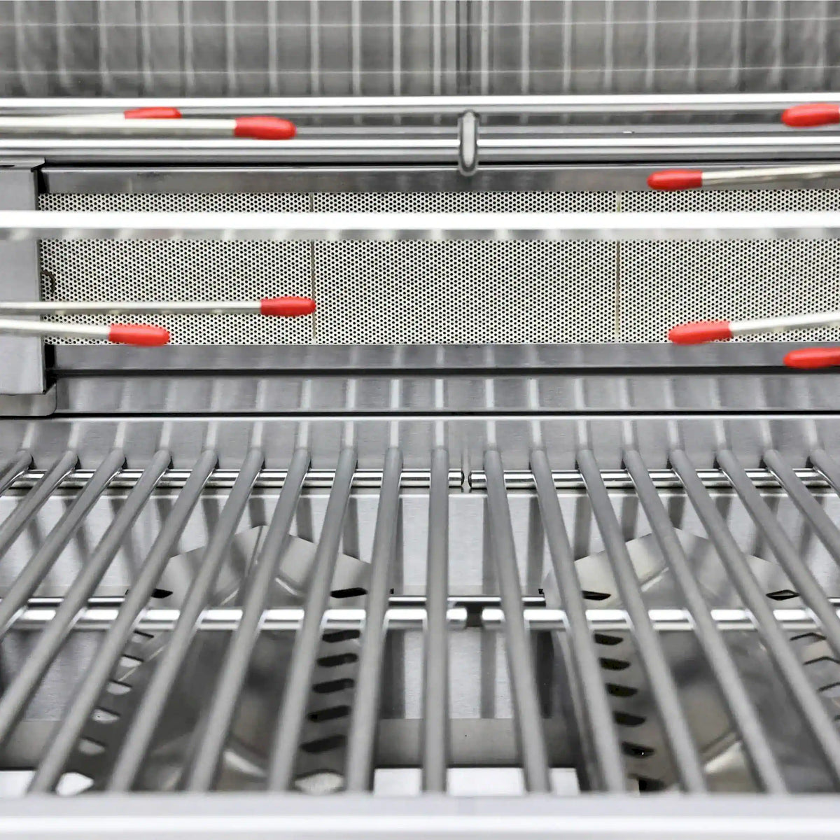 Stainless steel BBQ grill cooking grates with burner flavor bars visible