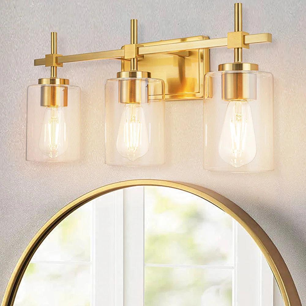 3-light bathroom vanity light with golden metal frame and clear glass shades