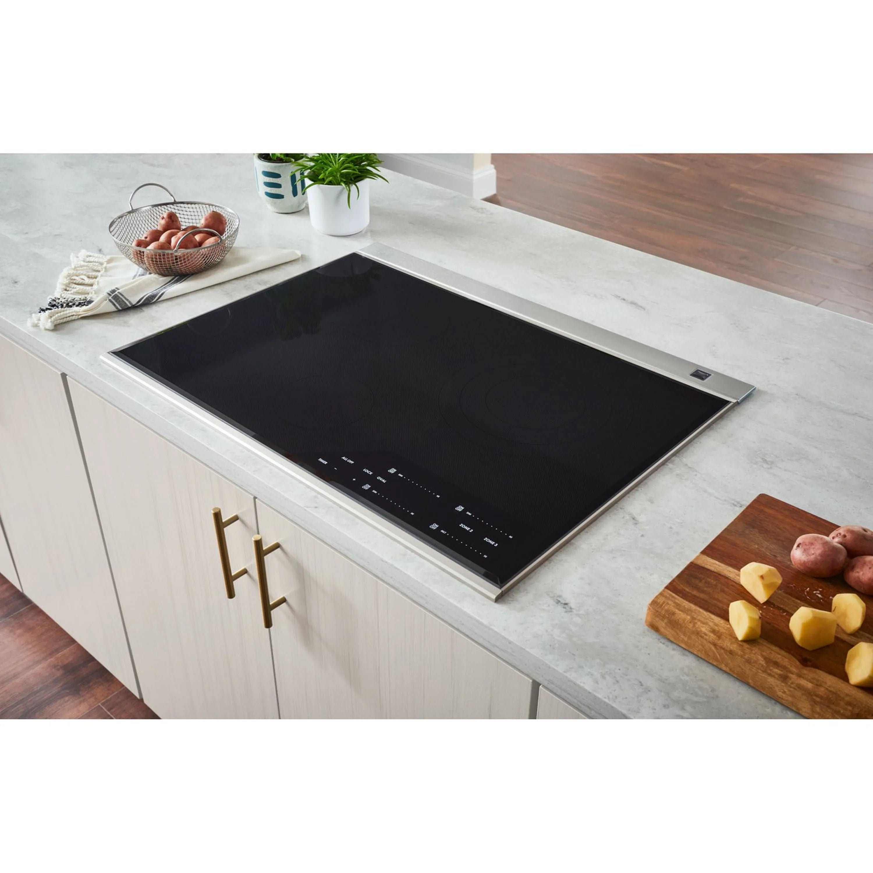 Stainless steel downdraft range hood with black cooktop vent opening and control area