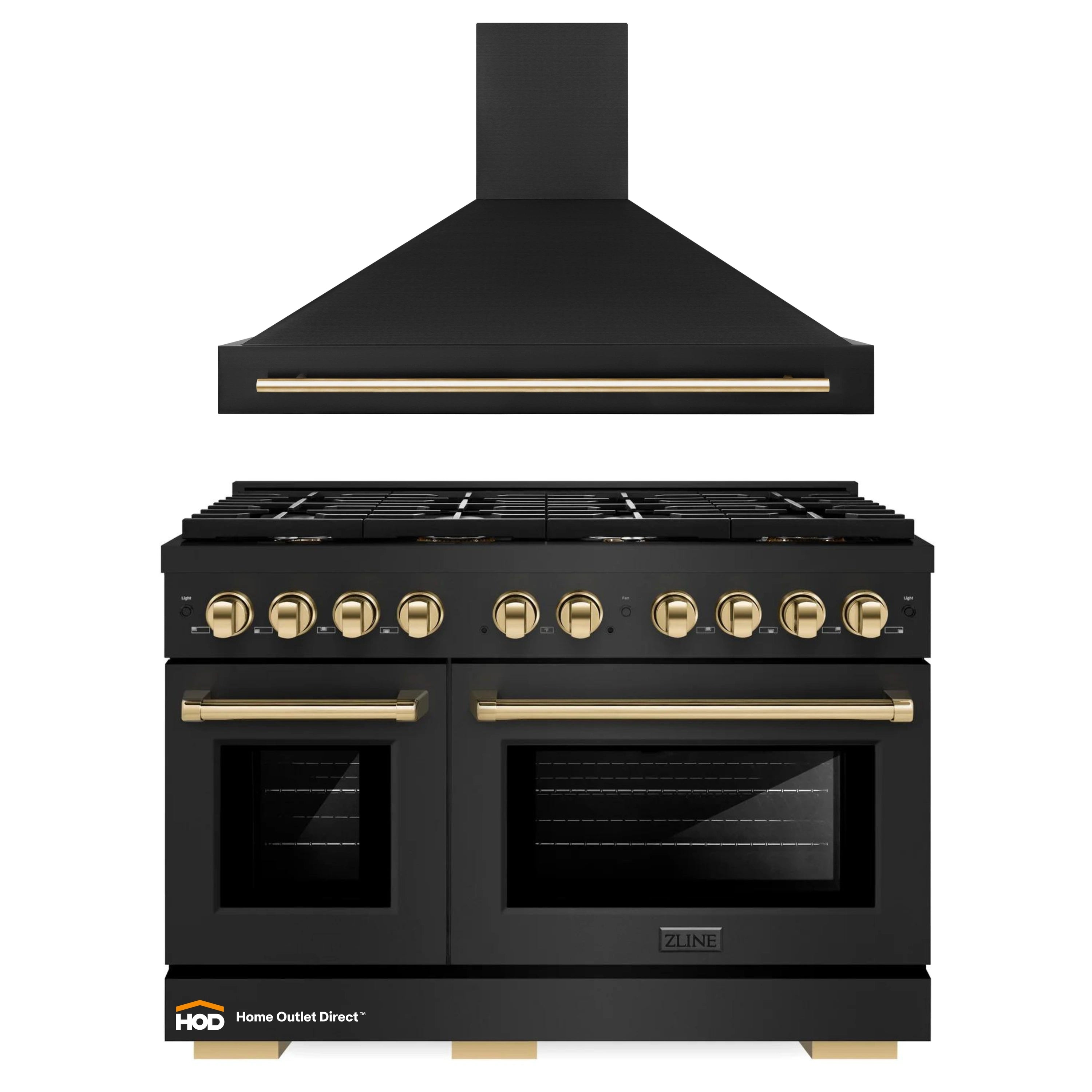 Black gas range with stainless wall hood and gold-accented control panel