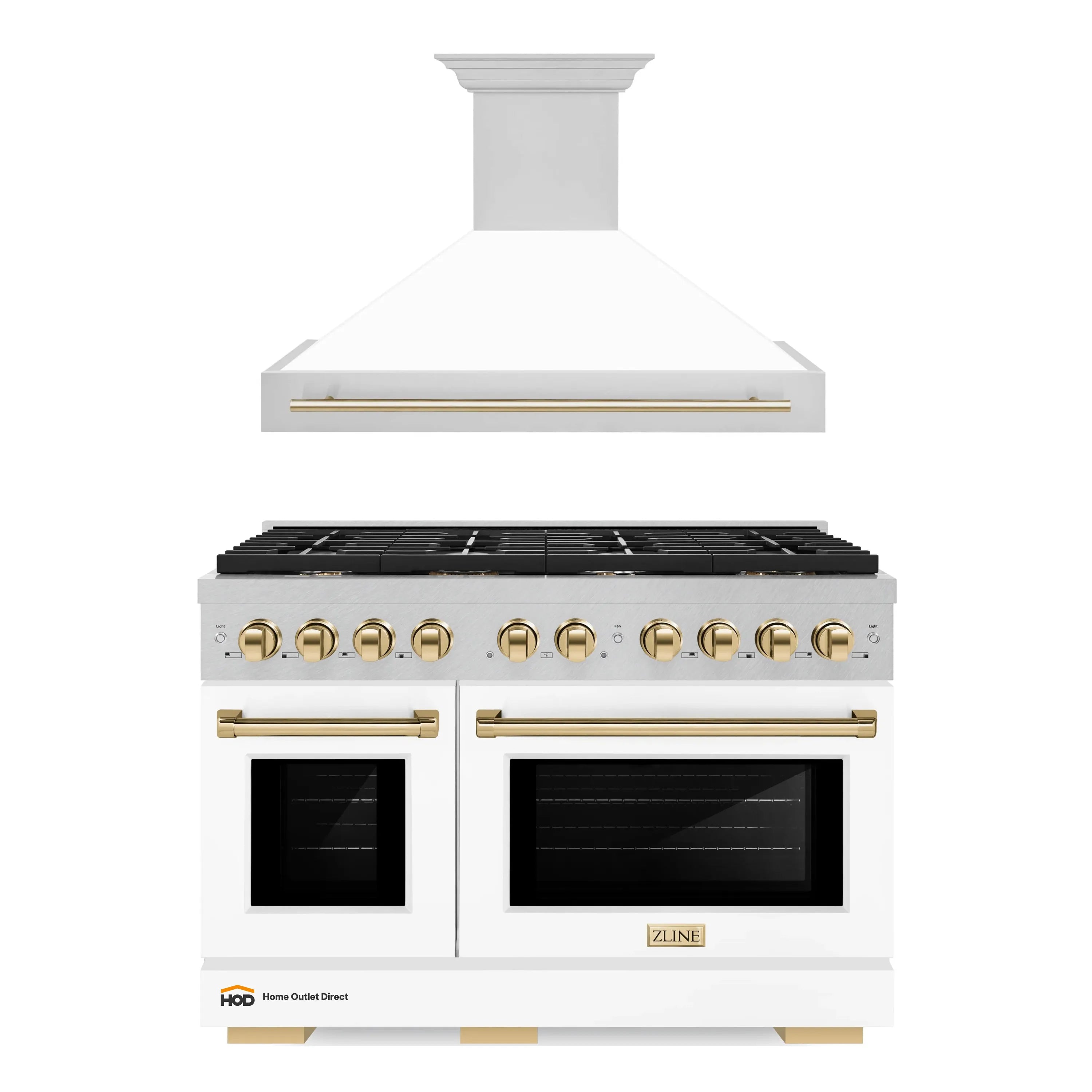 Gas range with wall-mounted hood, white doors, gold trim, and satin stainless surfaces